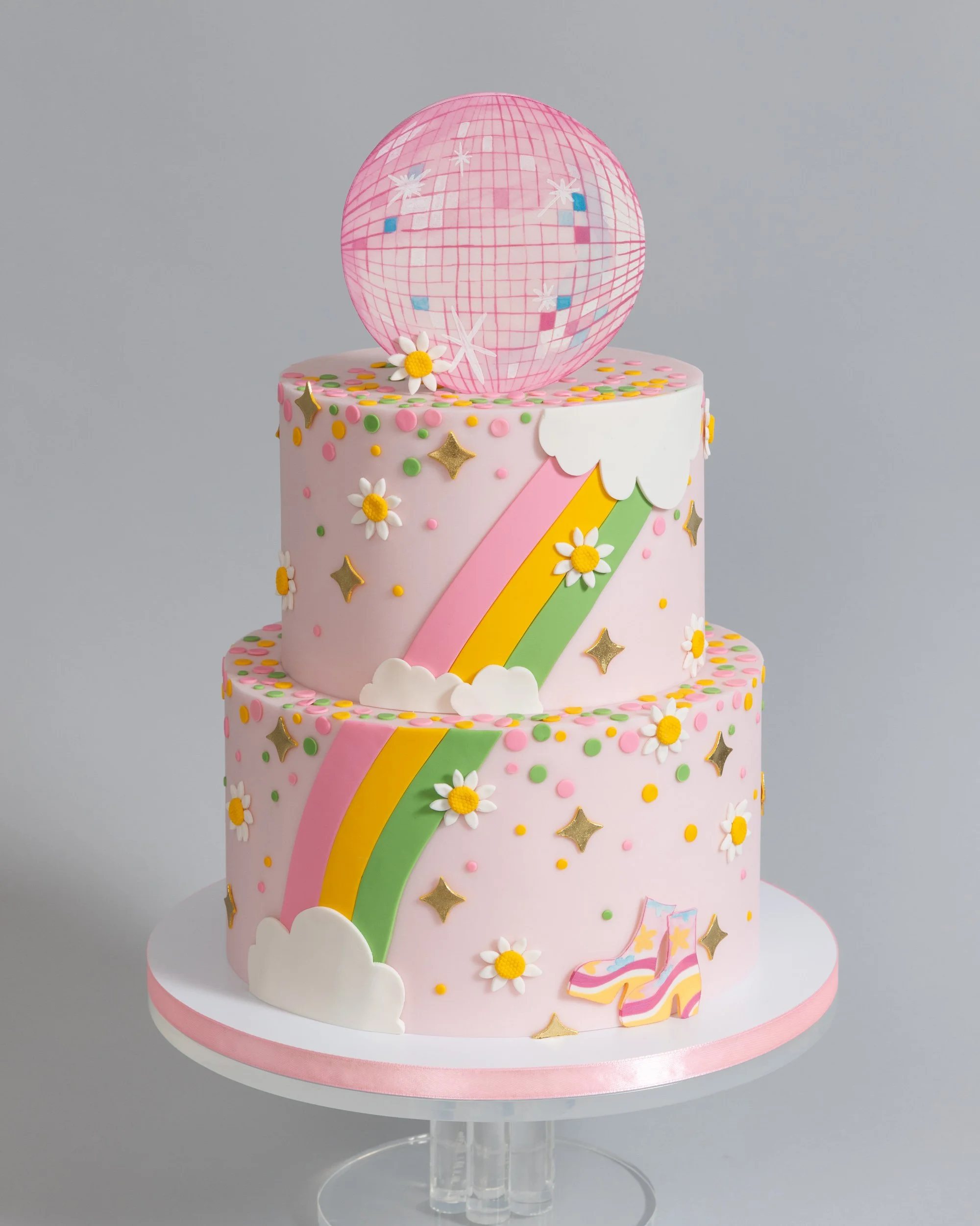 70s themed pink disco cake with disco ball rainbow rollerskates sparkles and daisies