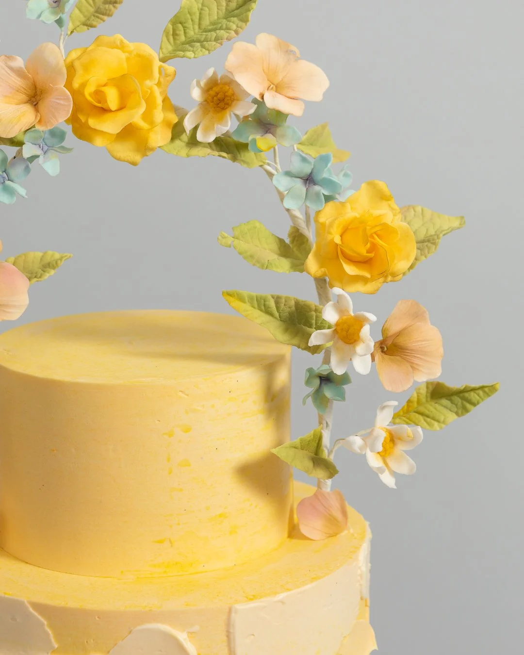 Halo of yellow roses on yellow birthday cake