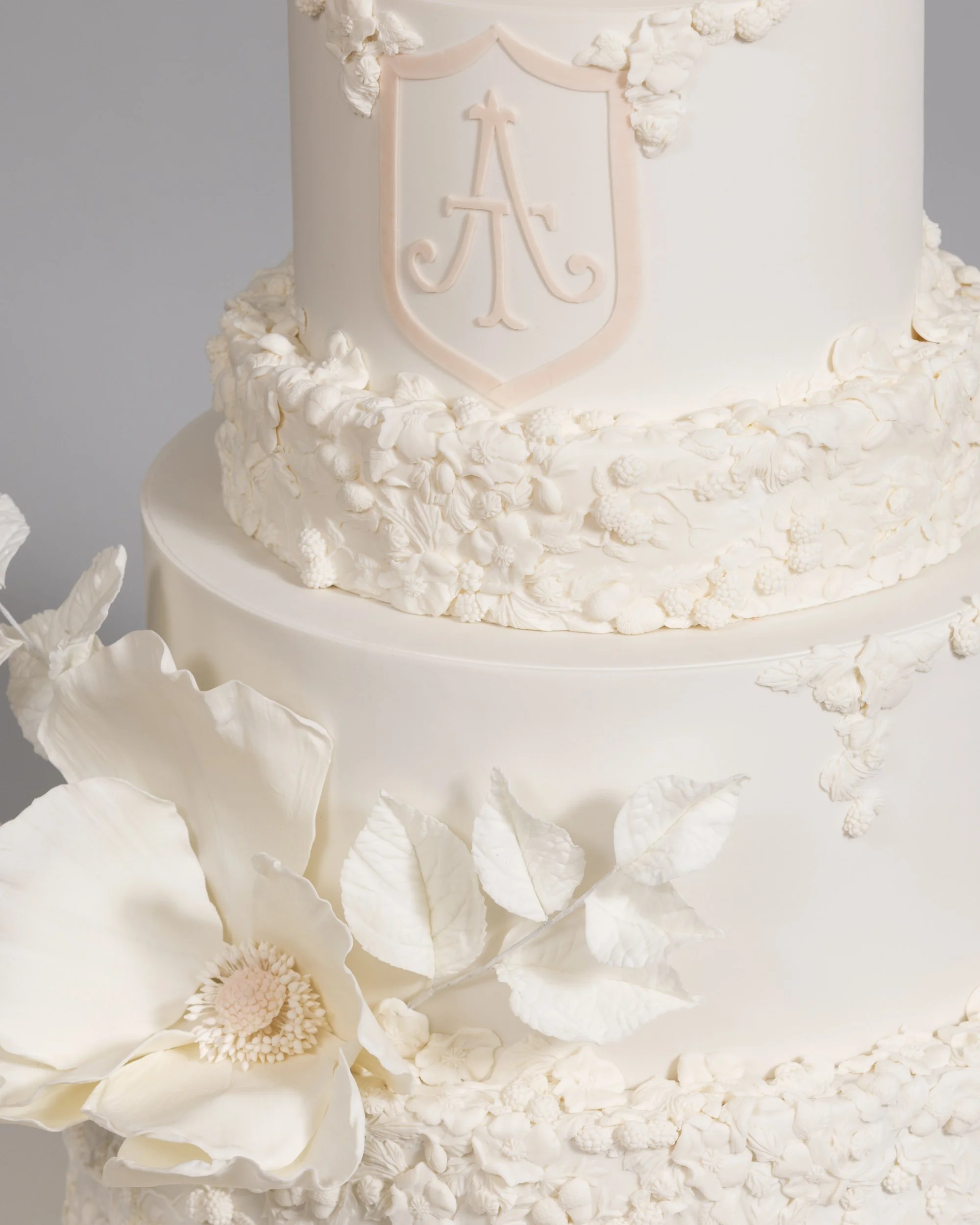 Detail of White Bas Relief Wedding Cake with Heraldry