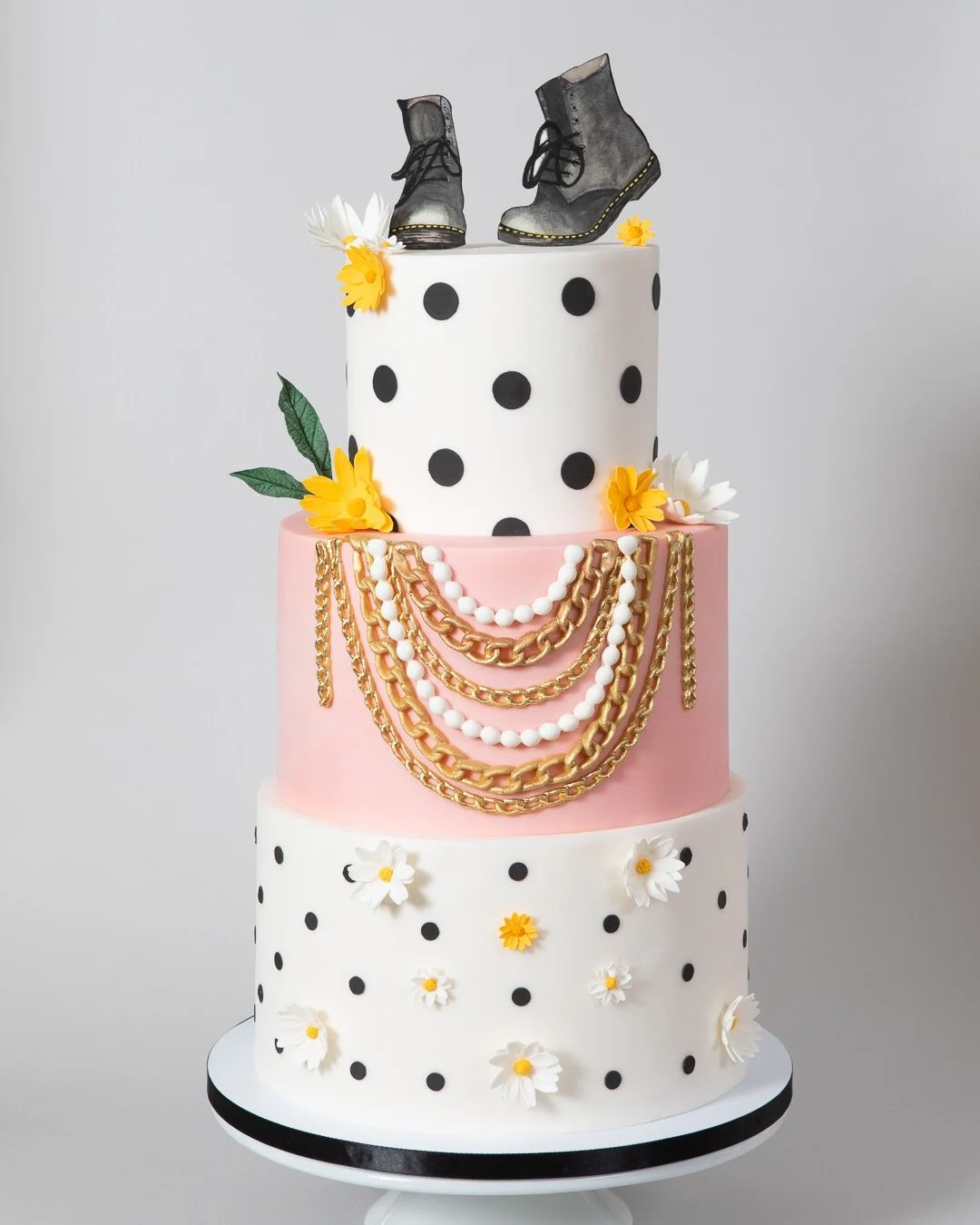 90s themed birthday cake with gold chains, daisies, and Doc Martens