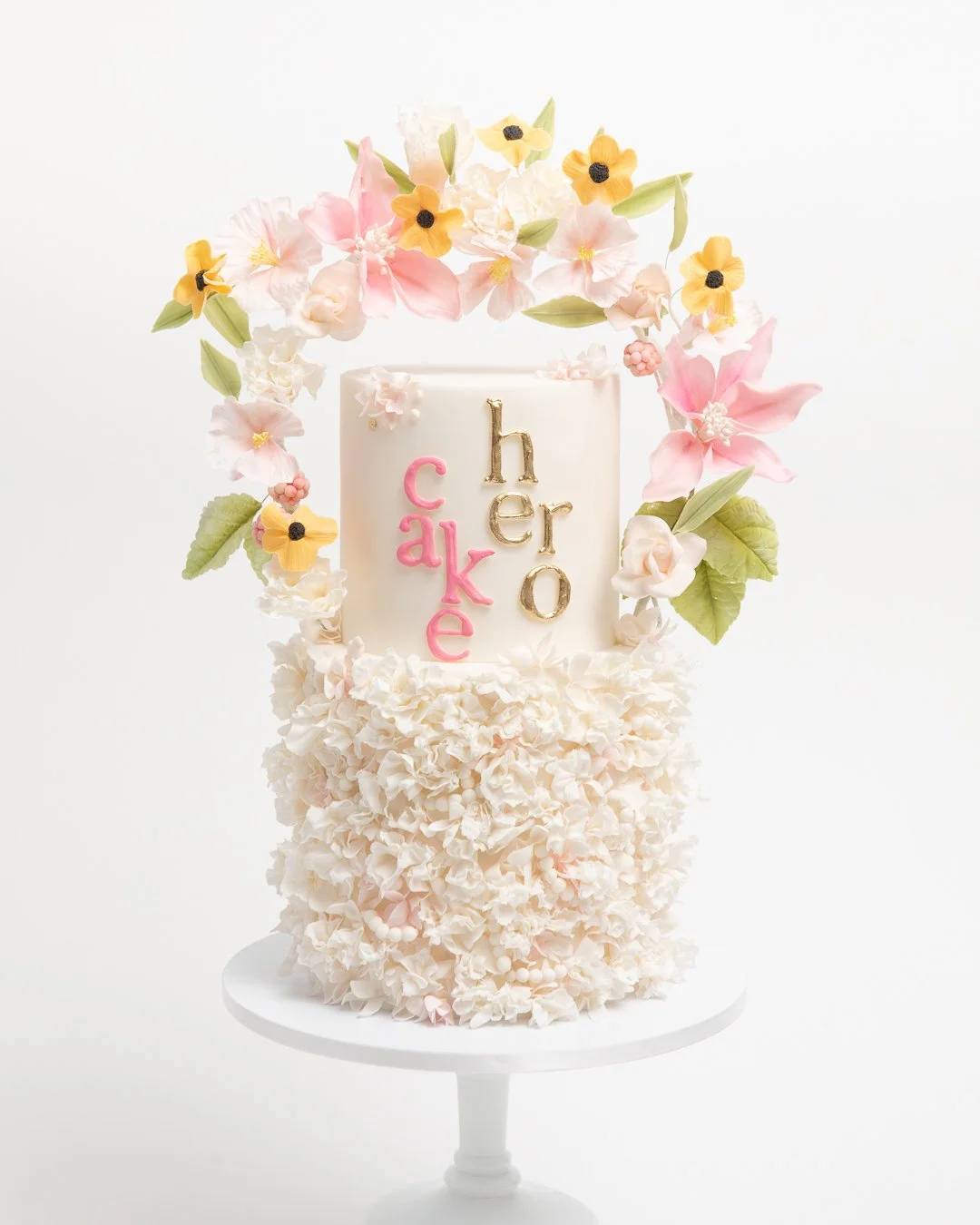 Cake Hero cake with yellow and pink flowers and ruffles 