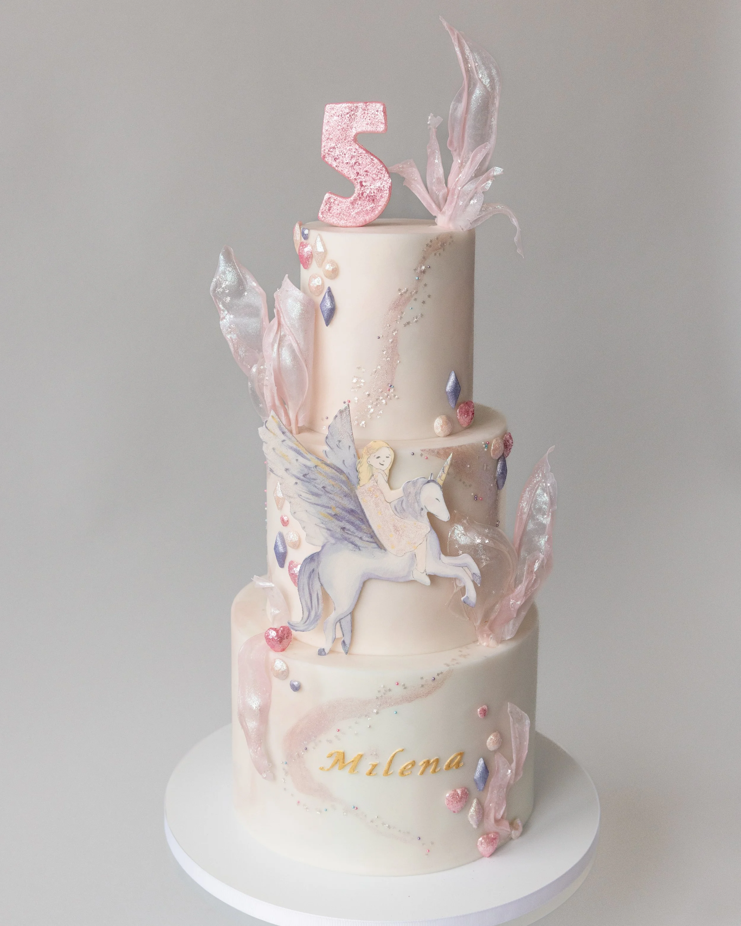 Magical girl's fifth birthday cake with sparkles, unicorn pegasus