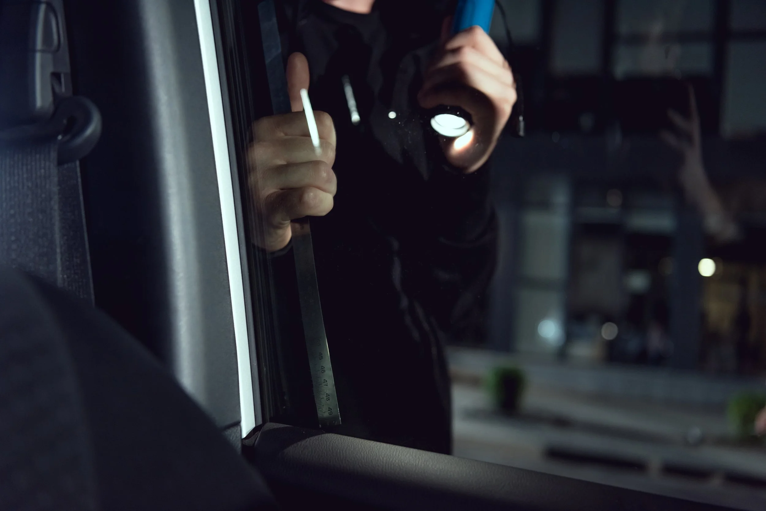 partial-view-of-thief-intruding-car-with-flashligh-2026-03-11-08-45-41-utc.jpg