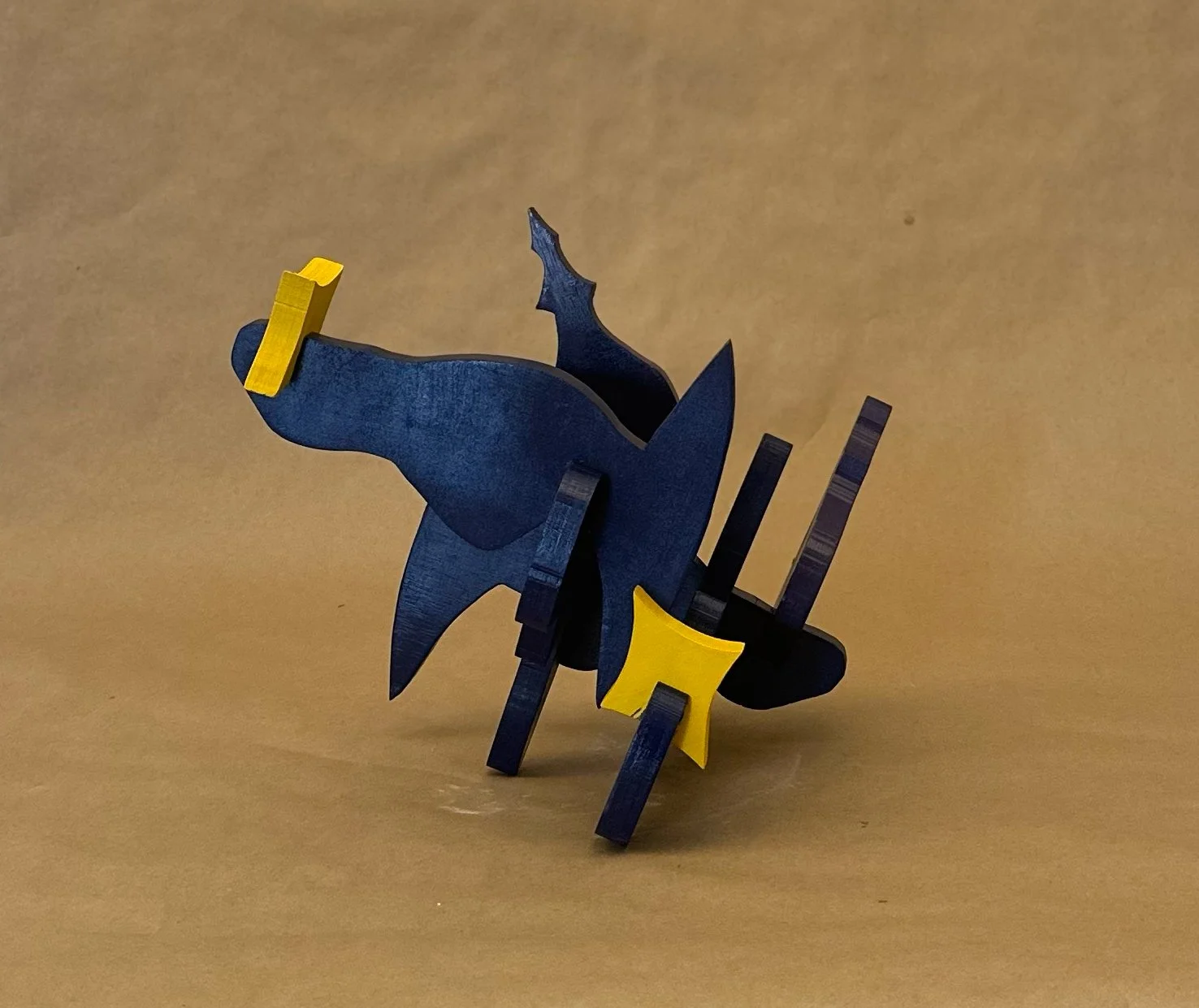 Abstract purple and yellow sculpture made of wood