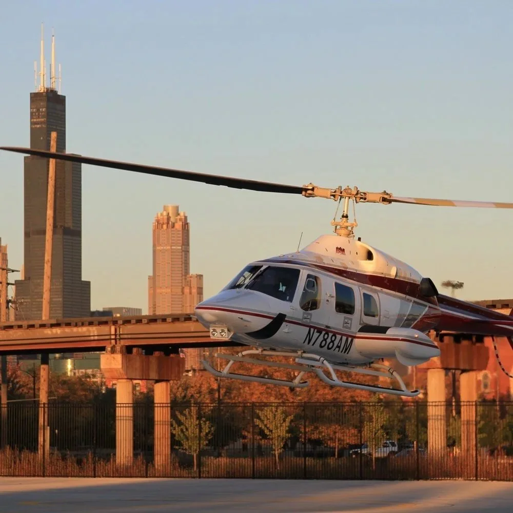 Helicopter flying in front of Chicago skyline during sunset
