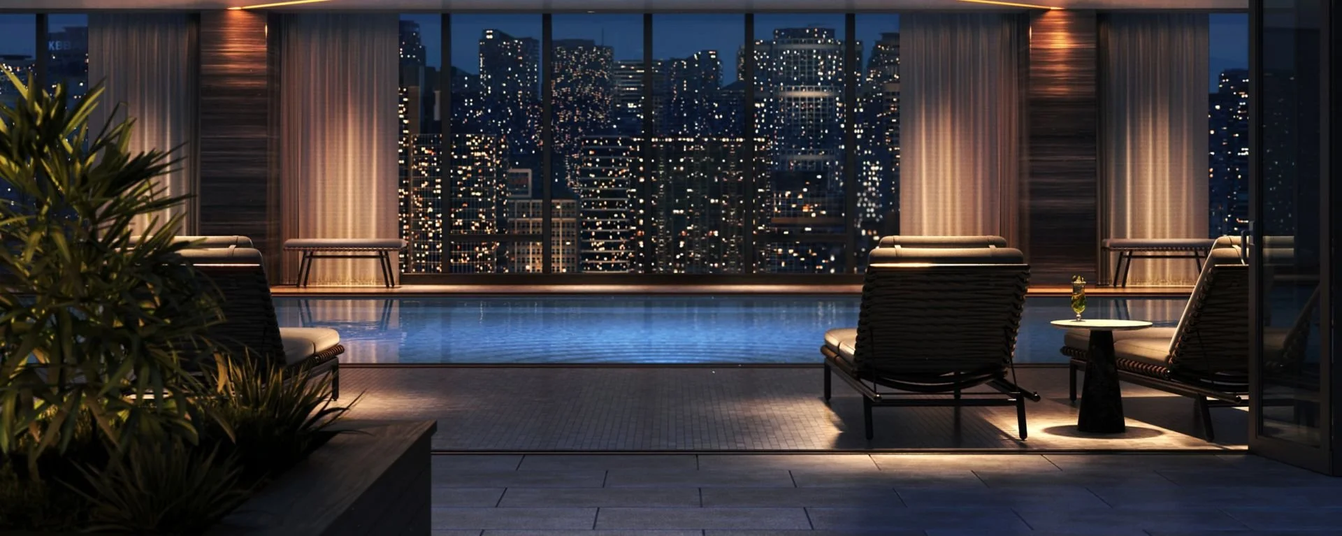 Luxury rooftop pool area at night with city skyline view, lounge chairs, potted plants, and curtained windows.