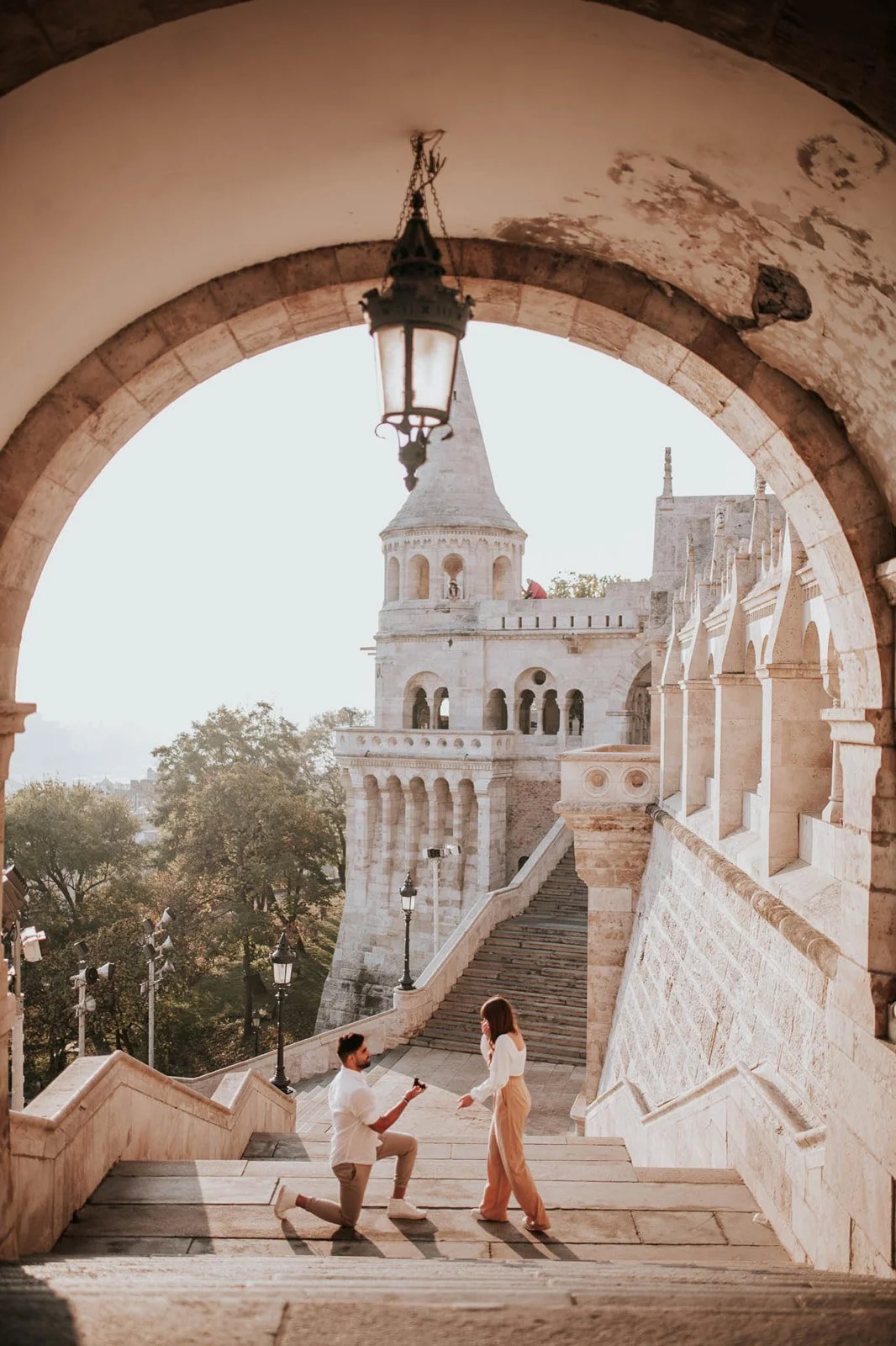 Proposal on the Fisherman’s Bastion staircase framed by the stone archway.