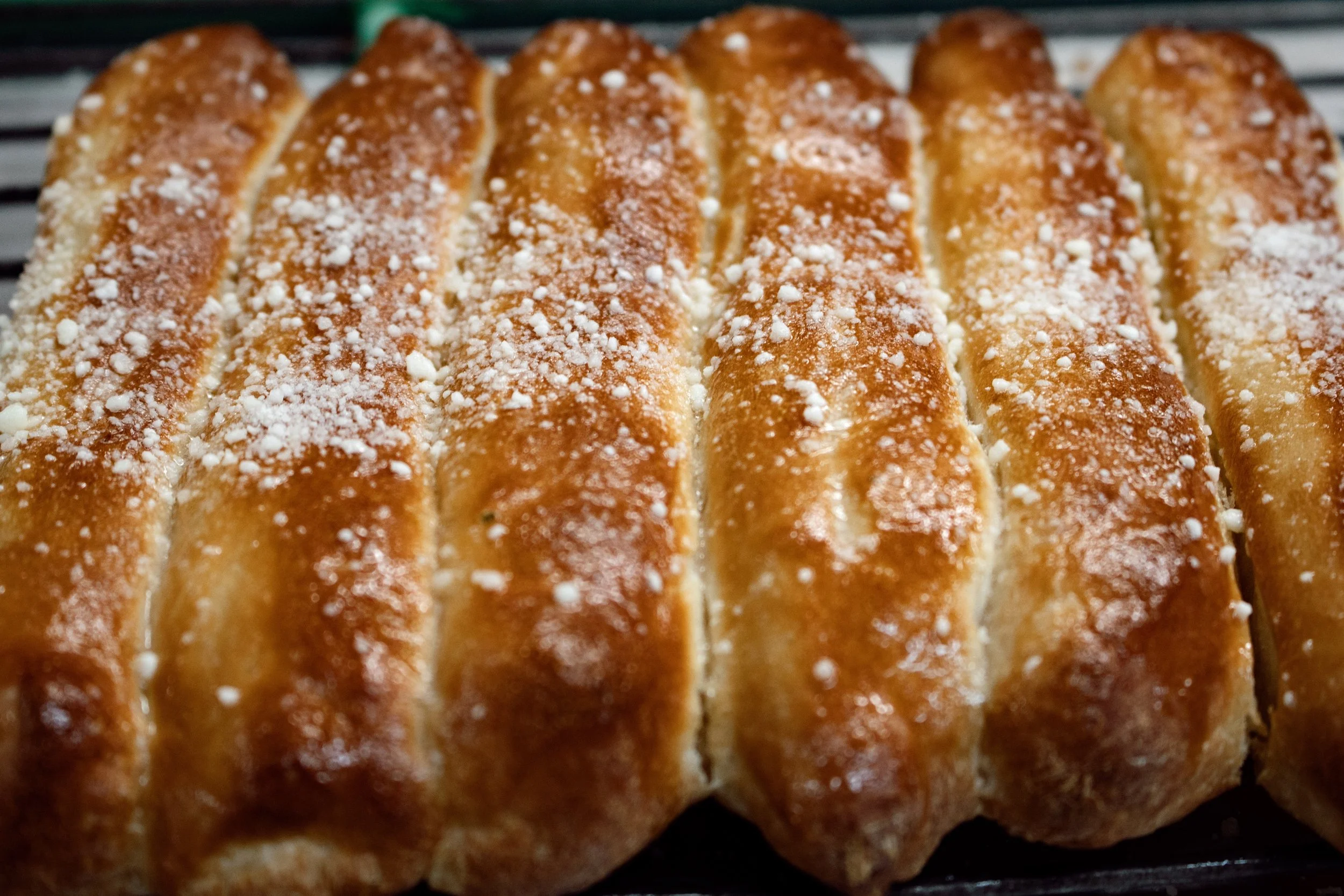 Close-up of freshly baked bread topped with parmesan cheese.