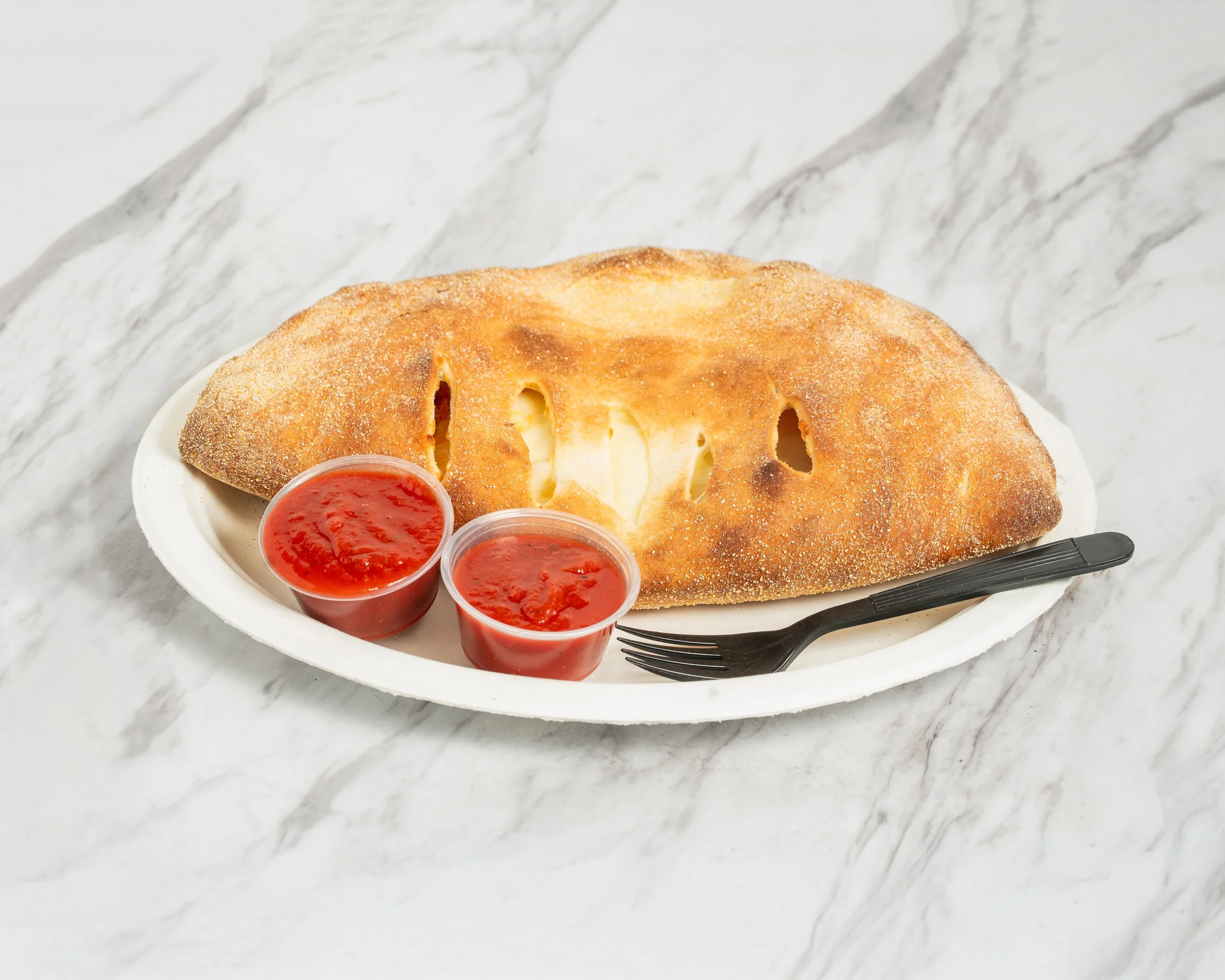 Cheesy cheese-filled calzone with two side cups of marinara sauce. Best Calzone in Rochester NY