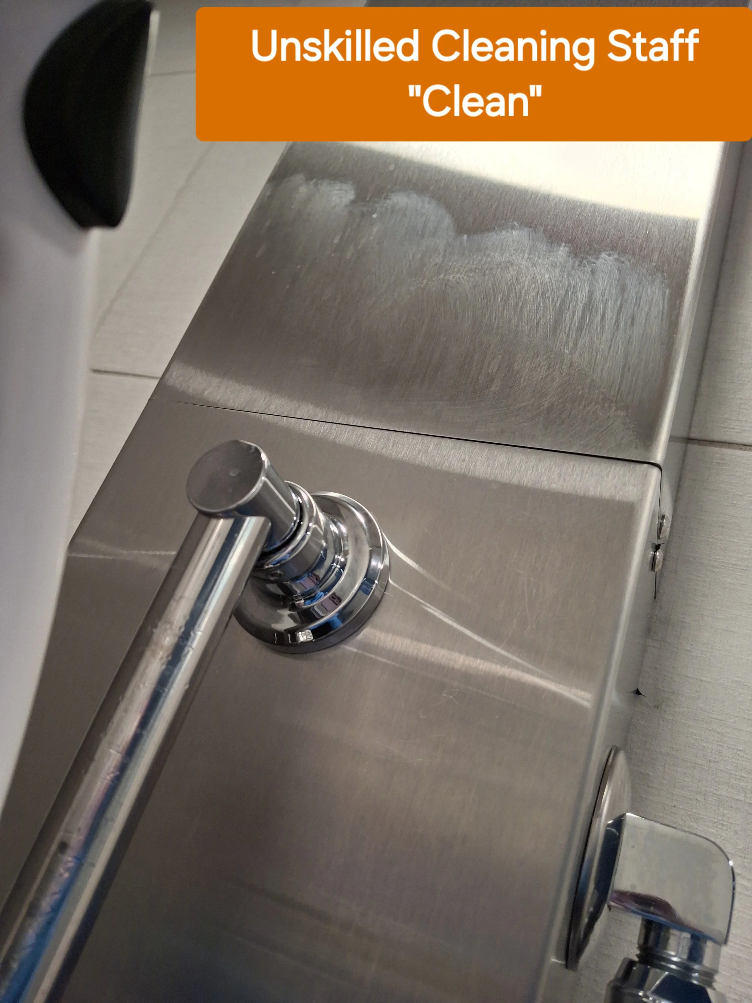 uncleaned stainless steel handicap shower in locker room in Evansville, Indiana