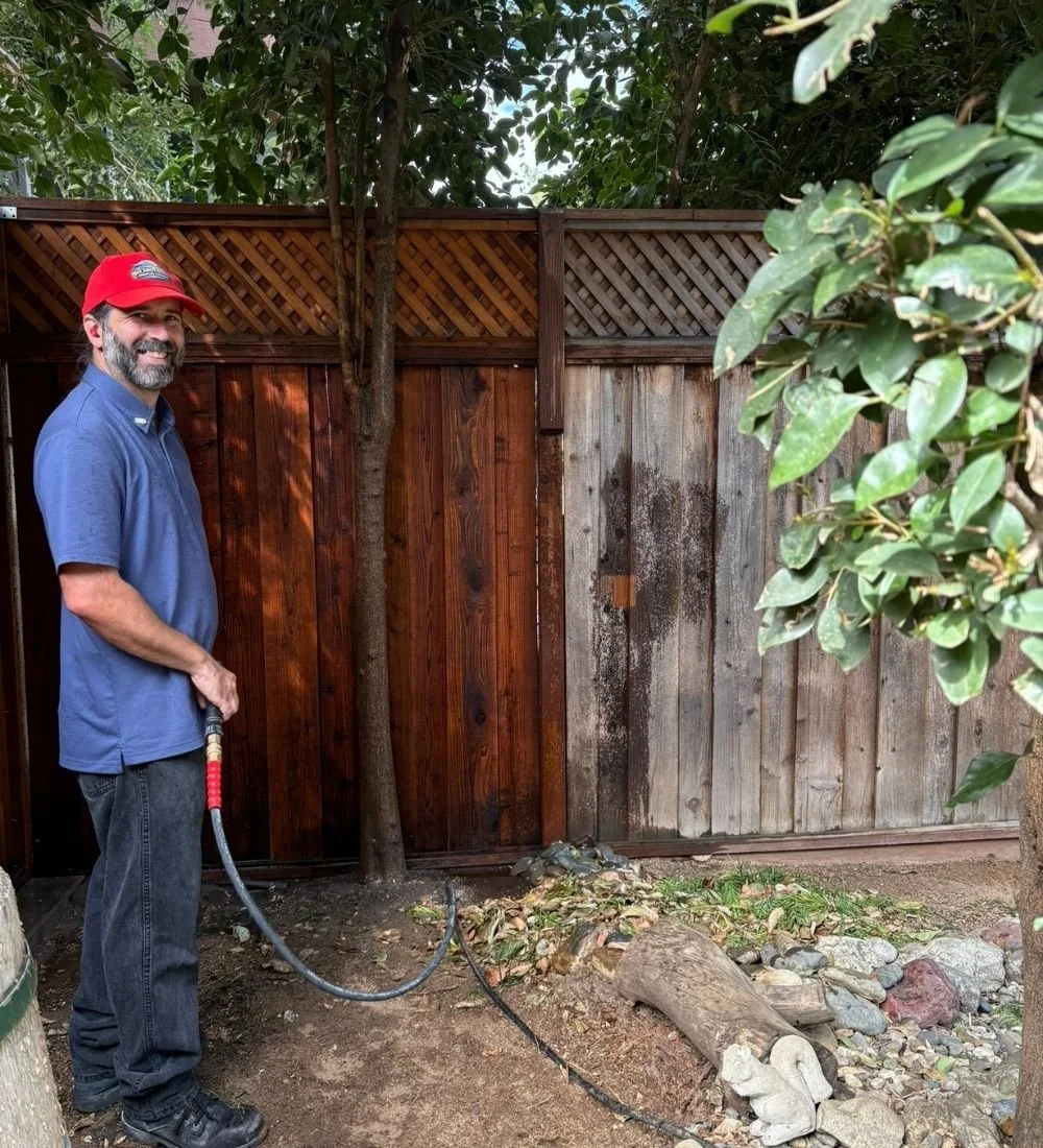 Solano County Pressure Washing owner cleaning a residential wood fence.