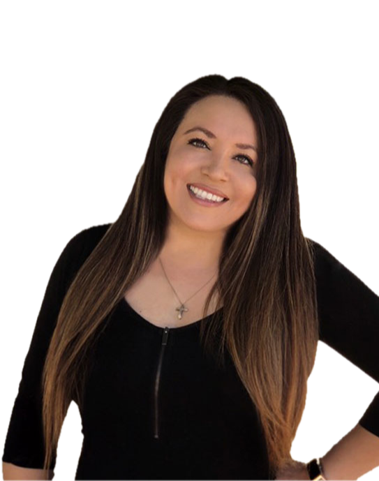 A woman with long brown hair and a bright smile, wearing a black top with a zipper and a cross necklace, posing against a plain background.