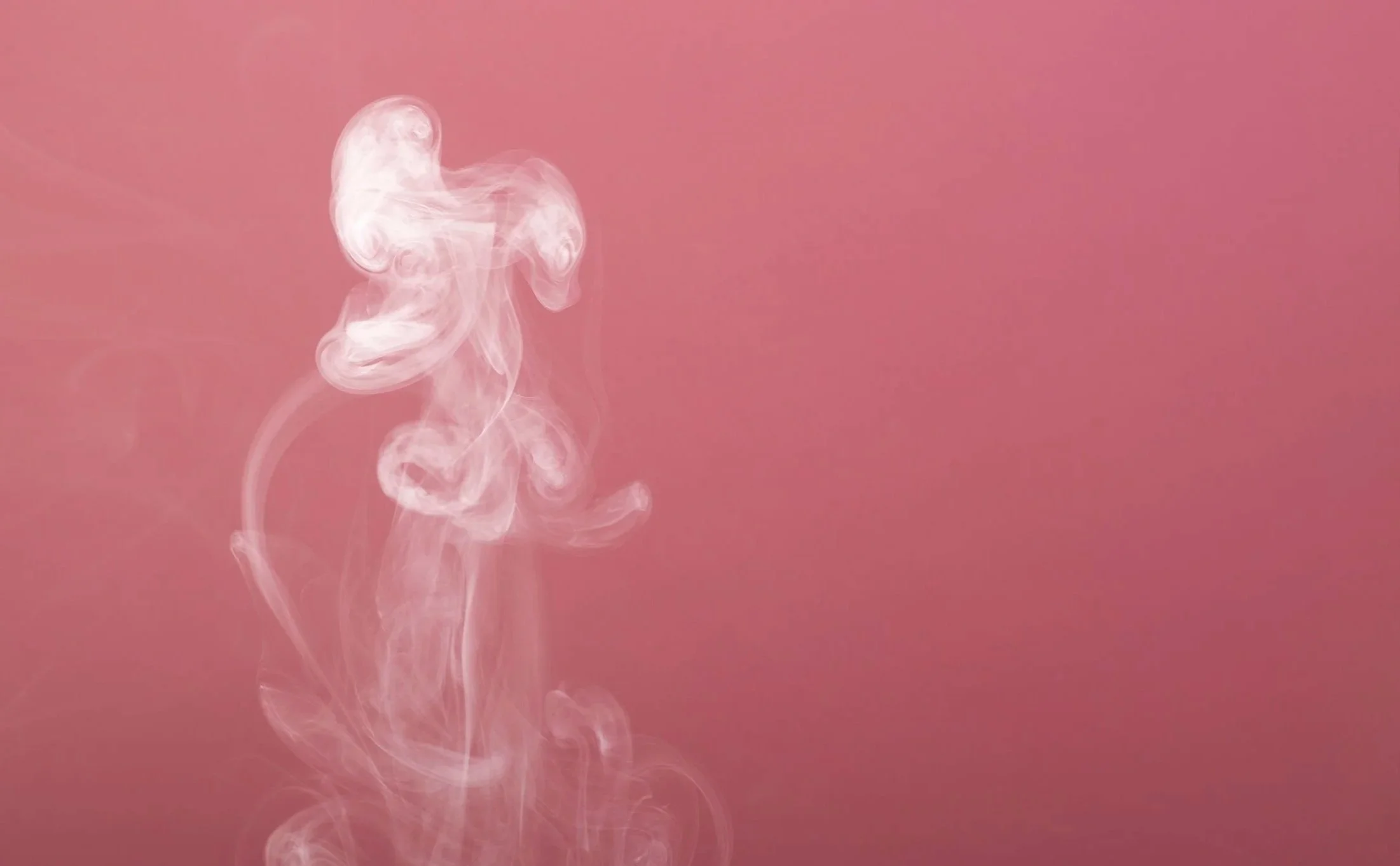 Pink background with white smoke swirling vertically.