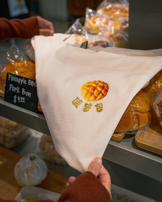 mills-market-pineapple-bun-graphic-tote-bag-bakery-display.png