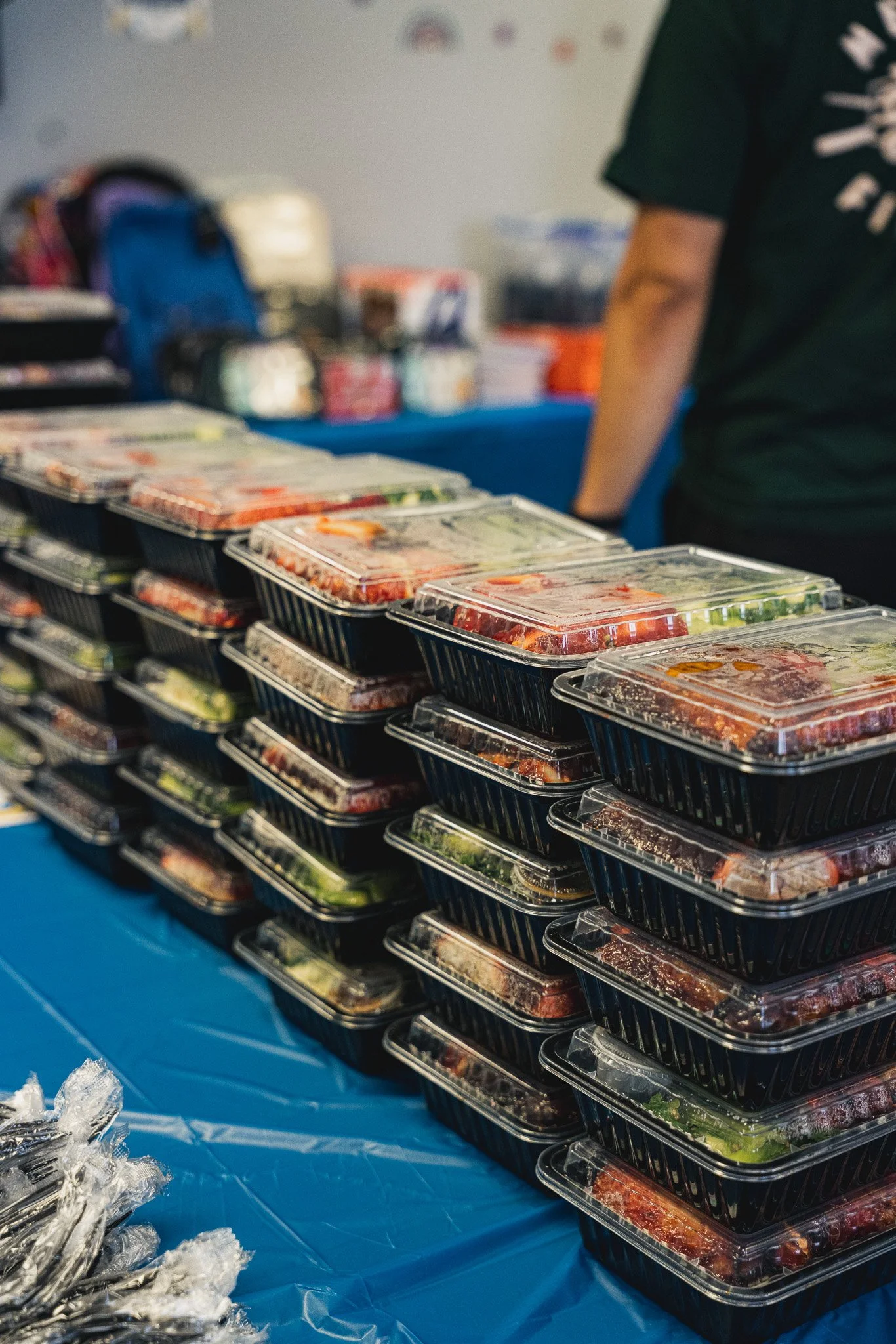 rows and stacks of hot boxed individual meals on a blue table