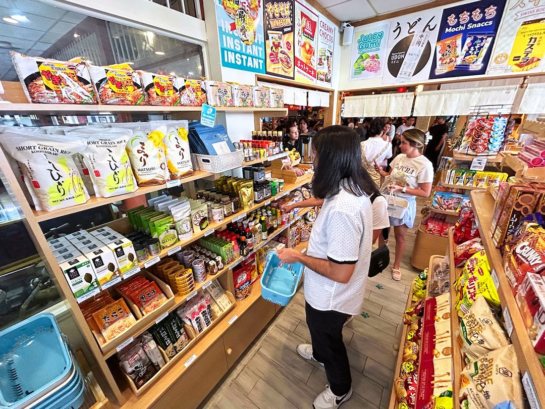 interior of Japanese convenience store shelves with shoppers