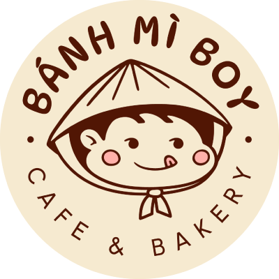 Logo for Bánh Mì Boy Café & Bakery featuring a cartoon boy with a rice hat, smiling and sticking his tongue out, with the café name underneath.