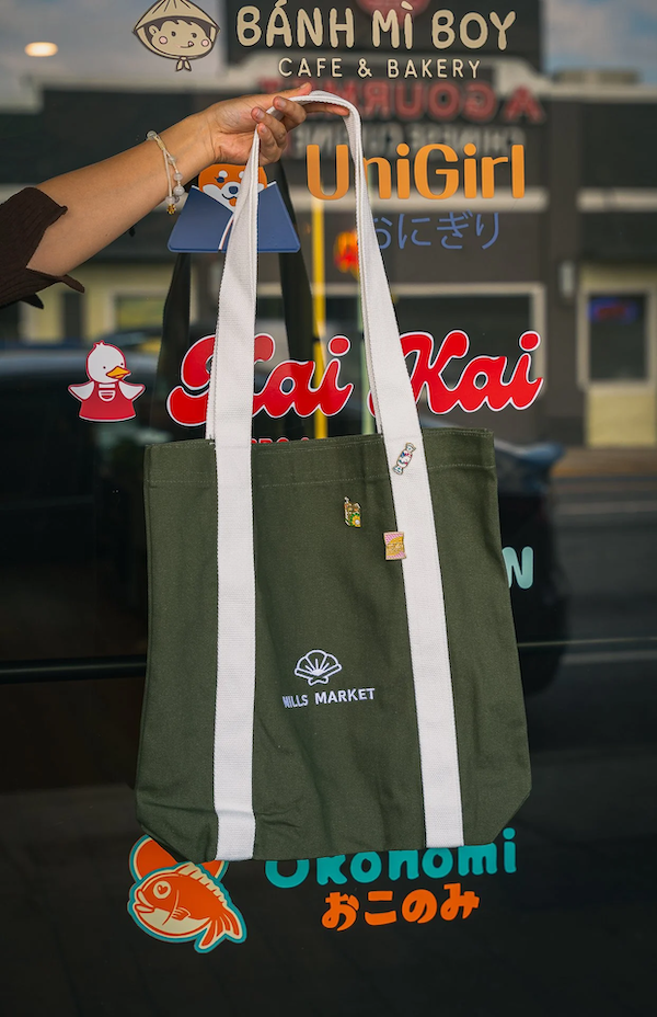mills-market-tote-bag-green-canvas-with-pins-and-partner-logos.png
