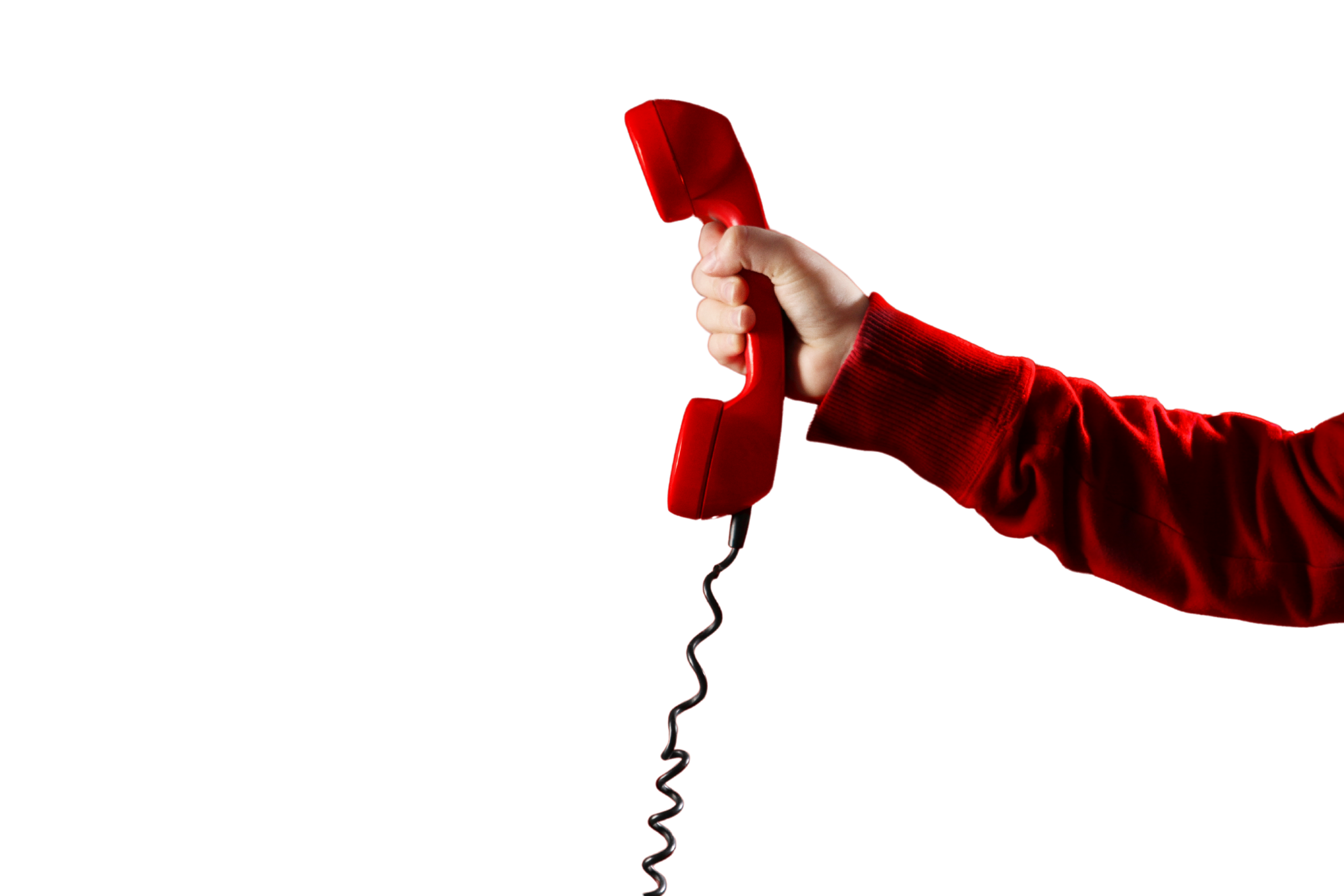 Person holding a red vintage rotary phone against a black background.