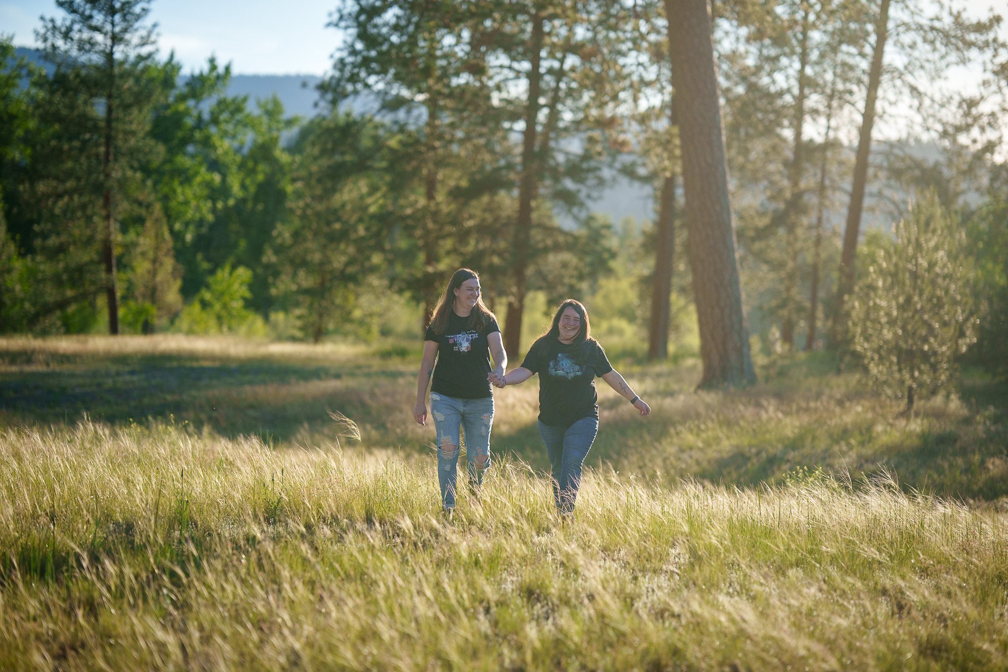 A couple holding hands walking in Council Groves Missoula Montana