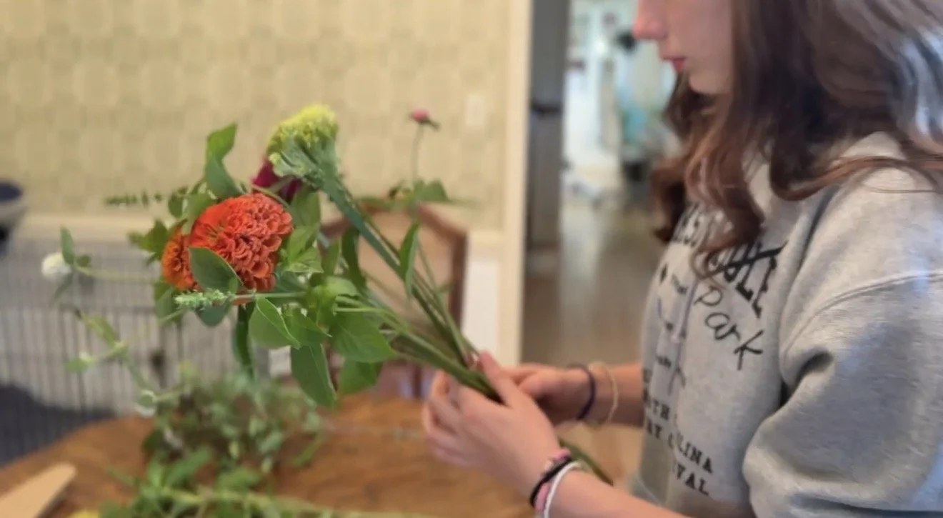 Person holding a bouquet of flowers