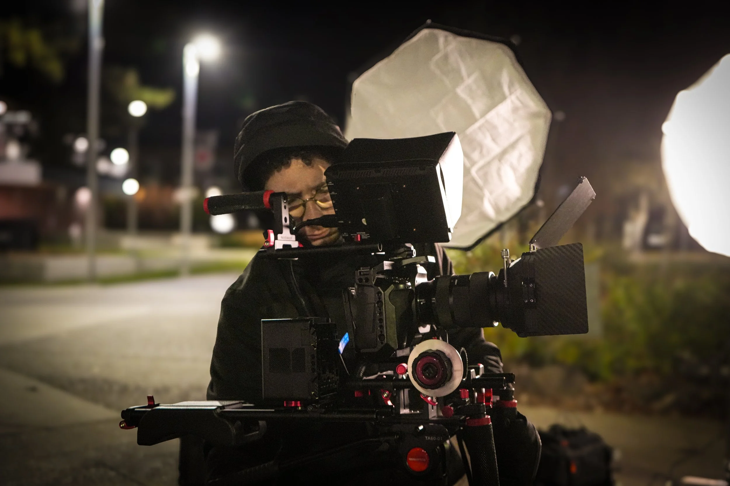 A filmmaker or photographer Nighttime commercial video production setup by ARC Lens Productions with professional lighting equipment