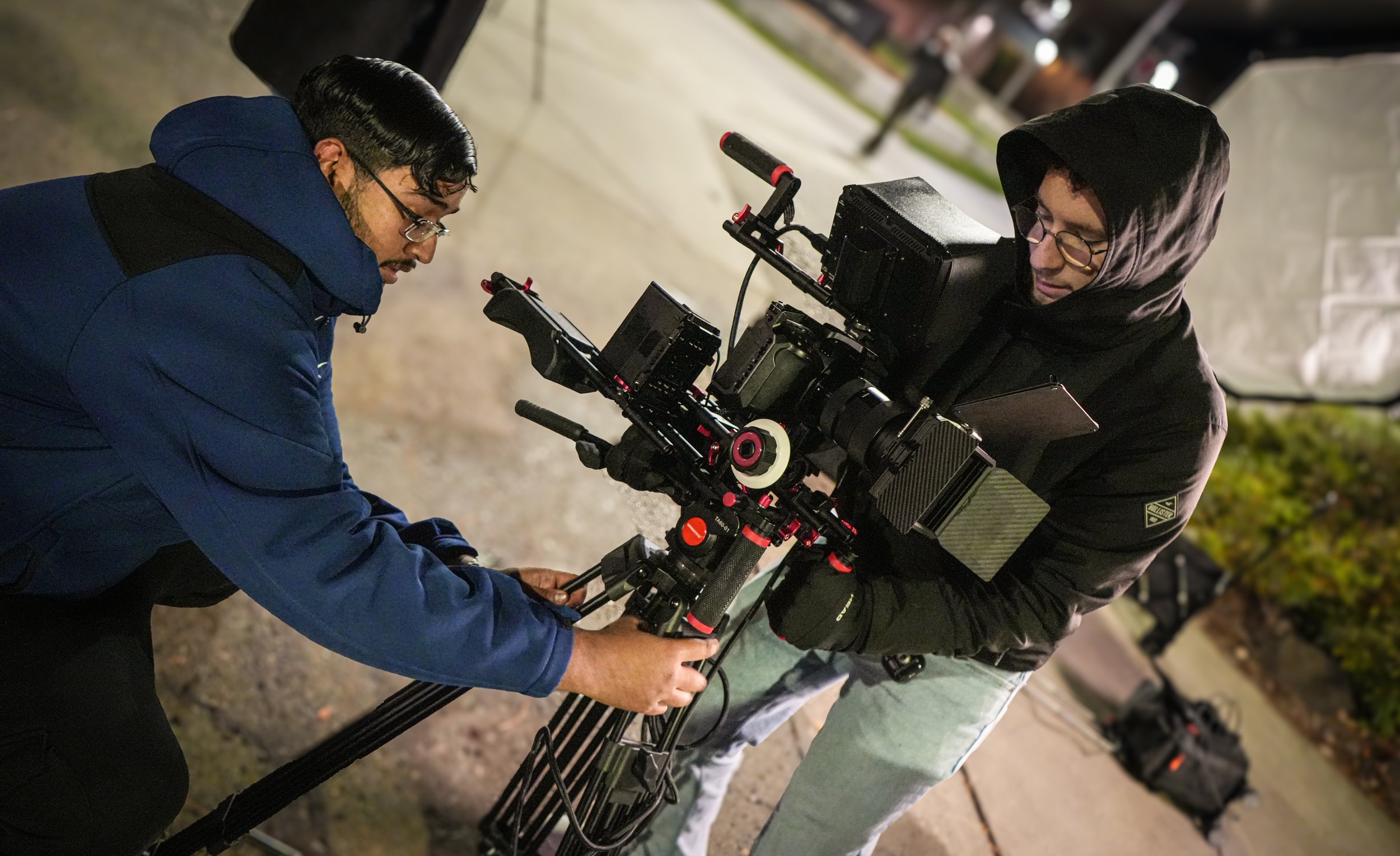 Gurdil Dardi Film Director helping film crew operating cinema camera during nighttime production for ARC Lens Productions