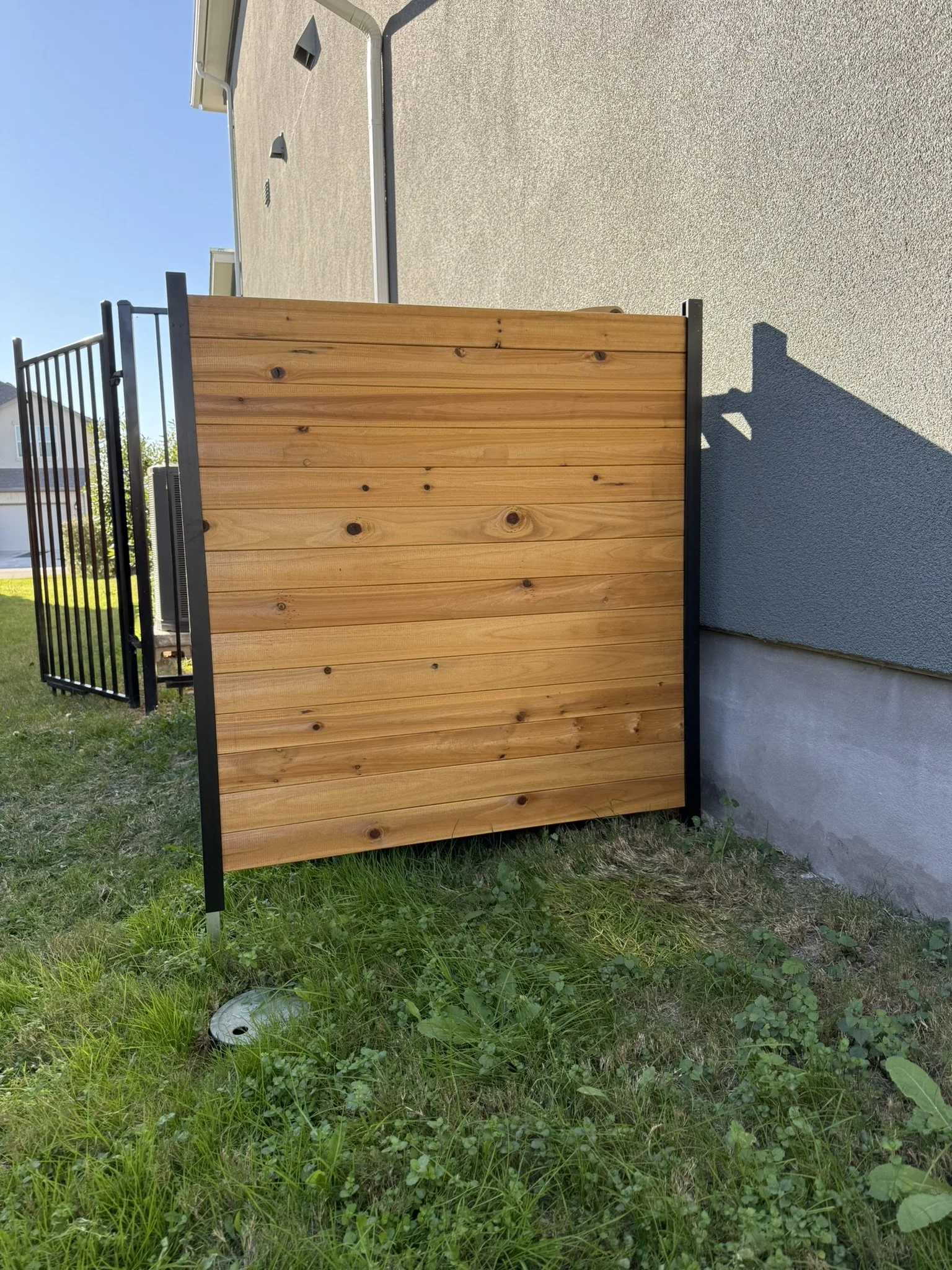 Trash bin fence install in stone ground