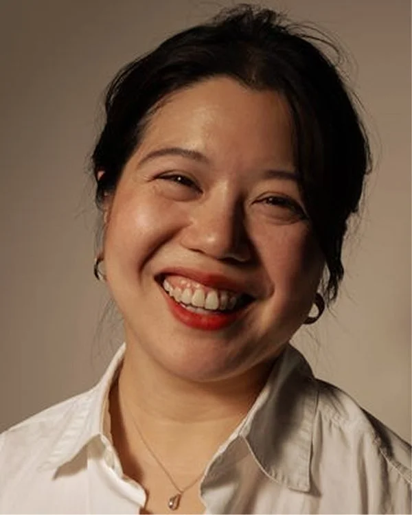Therapist Phing Tan smiling in a white collared shirt