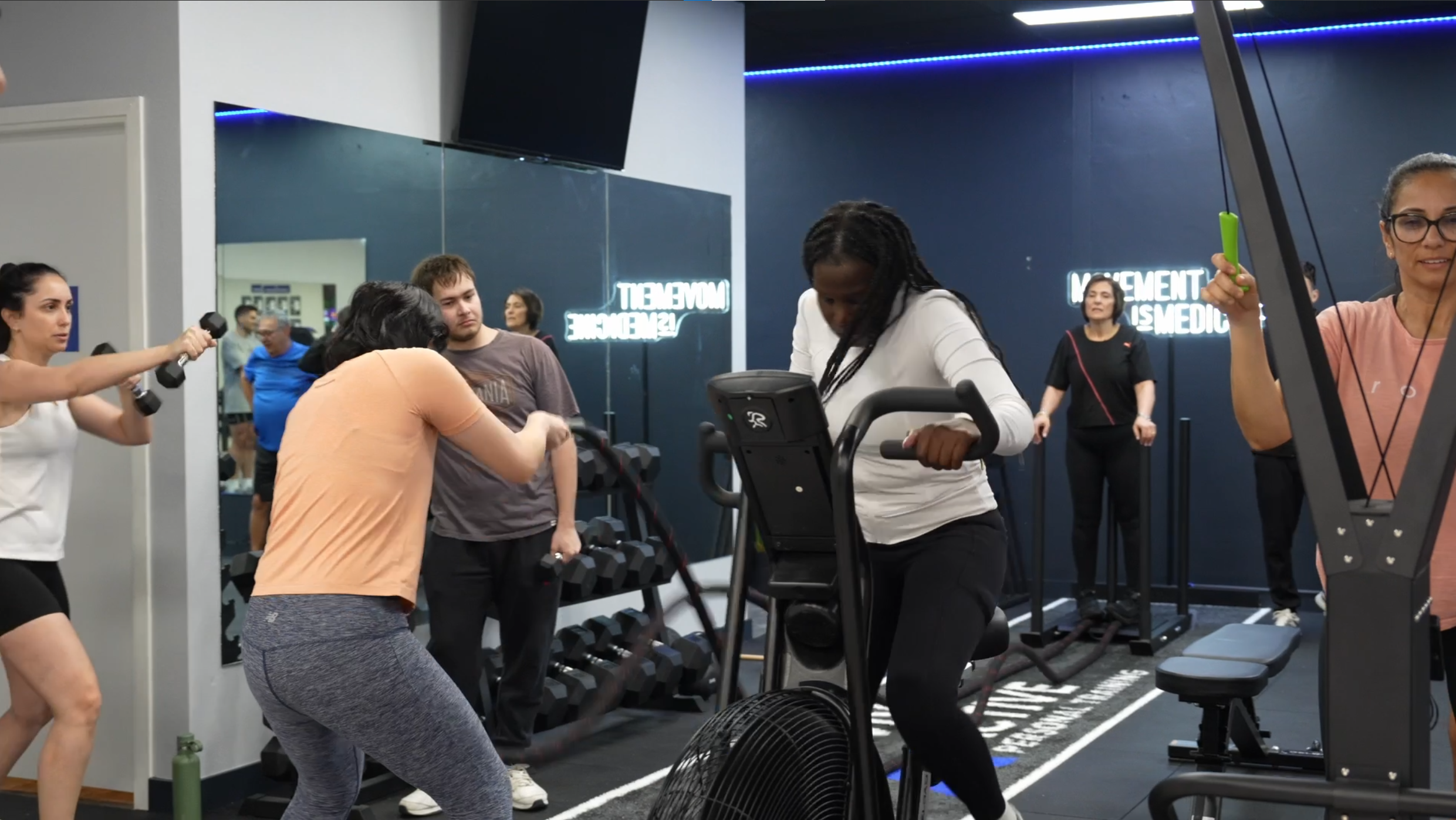 Semi-private personal training session at Viva Active Burwood using dumbbells and assault bike.