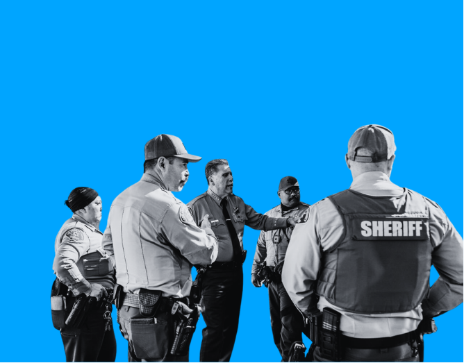 Law enforcement officers, including sheriff and police, standing in a discussion, against a blue background.