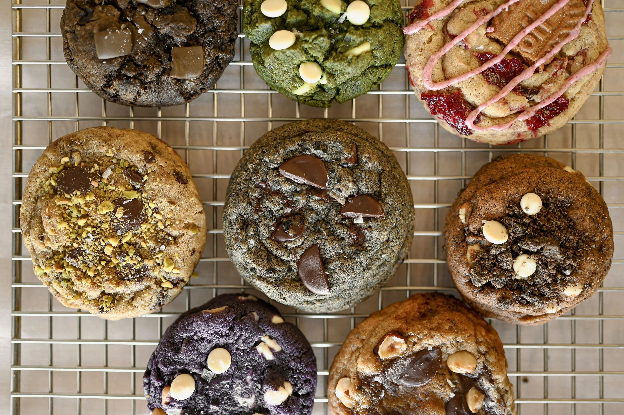 Assortment of small-batch brown butter cookies on a cooling rack, featuring Asian-inspired and classic flavors.