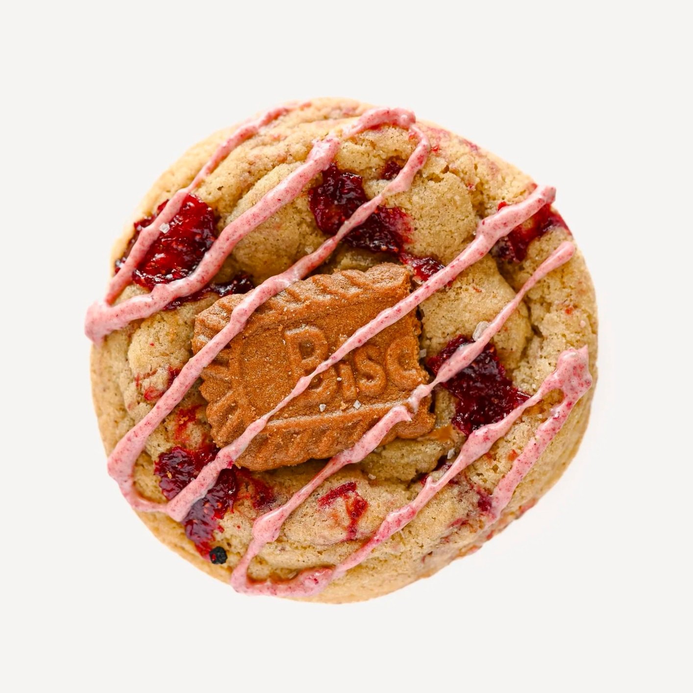 Strawberry Biscoff cookie with housemade strawberry jam swirled throughout the dough, topped with a Biscoff cookie piece, strawberry white chocolate drizzle, and flaky sea salt.