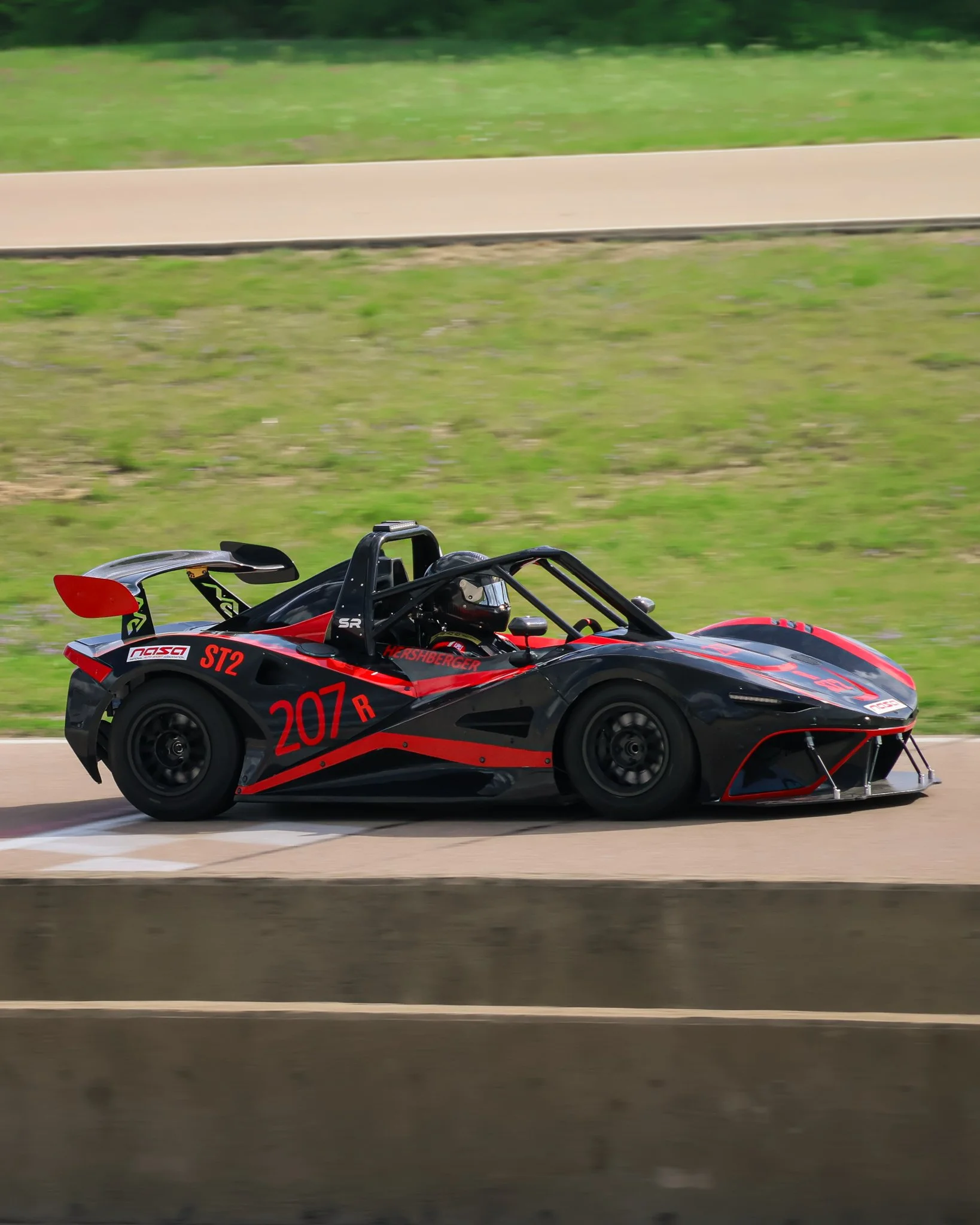 Black and red race car on a track