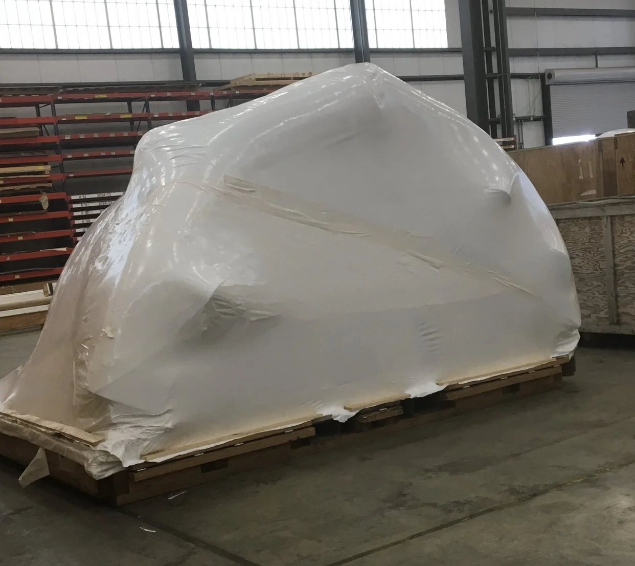 Equipment secured and shrink wrapped for protection during storage.