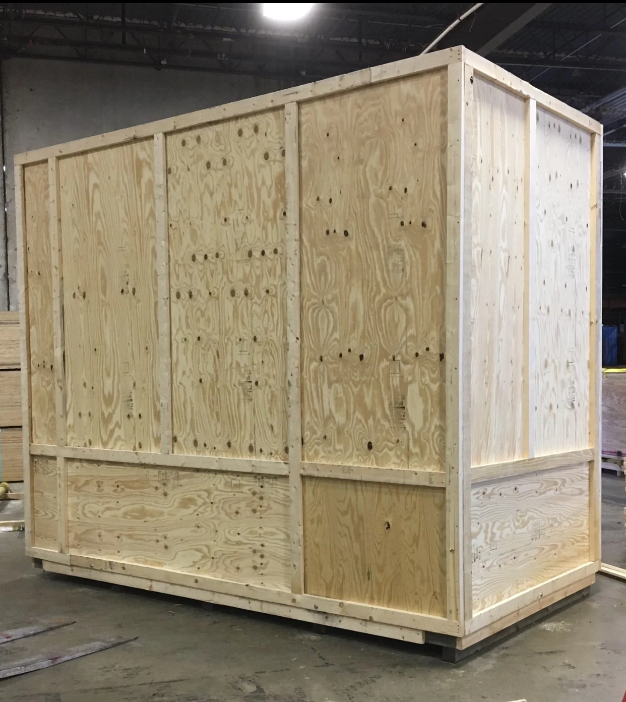 Industrial equipment secured inside a custom-built wooden crate, designed for safe transport and handling.