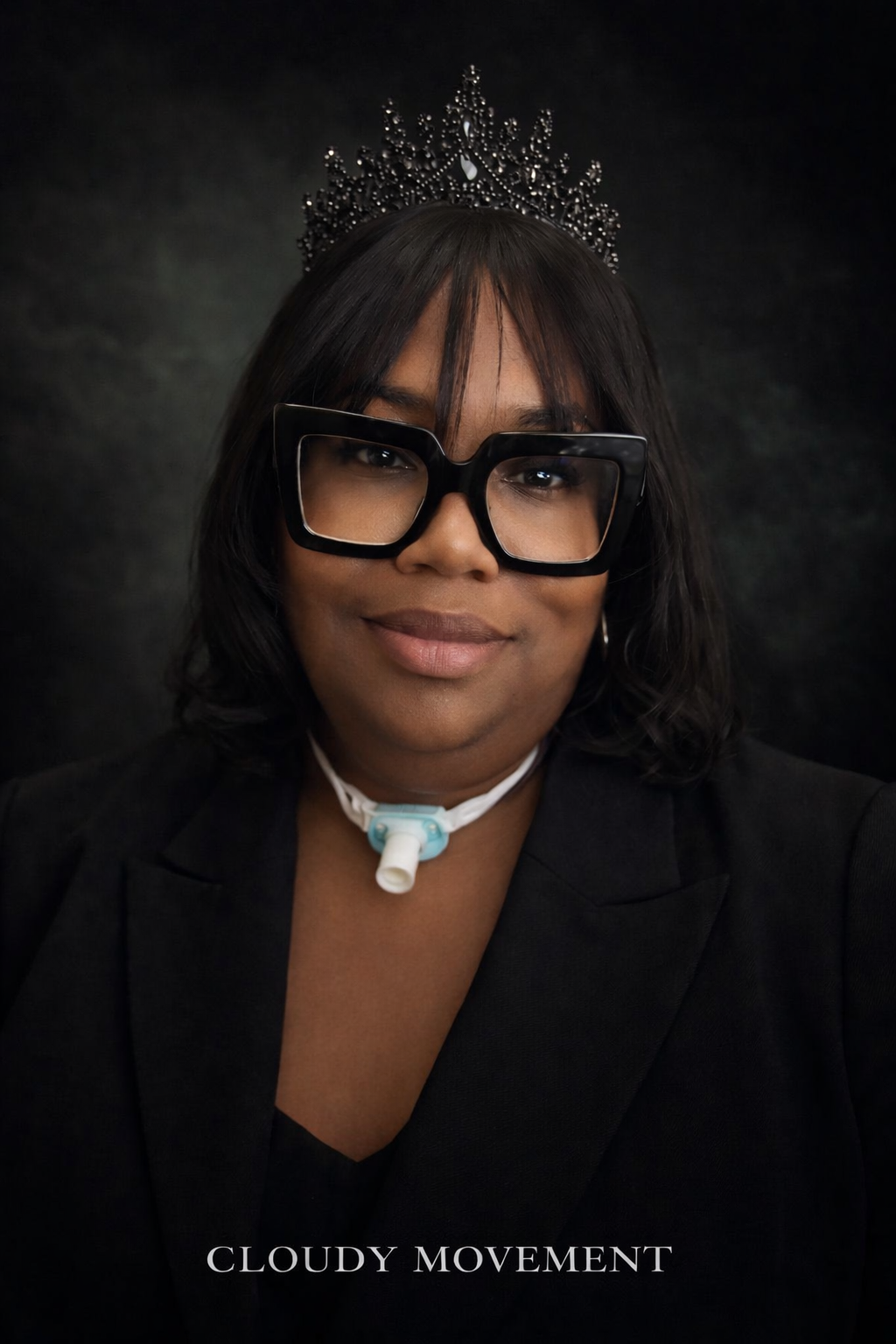 Woman wearing large black glasses, a tiara, and medical device around her neck, smiling against a dark background, with 'CLOUDY MOVEMENT' text at the bottom.