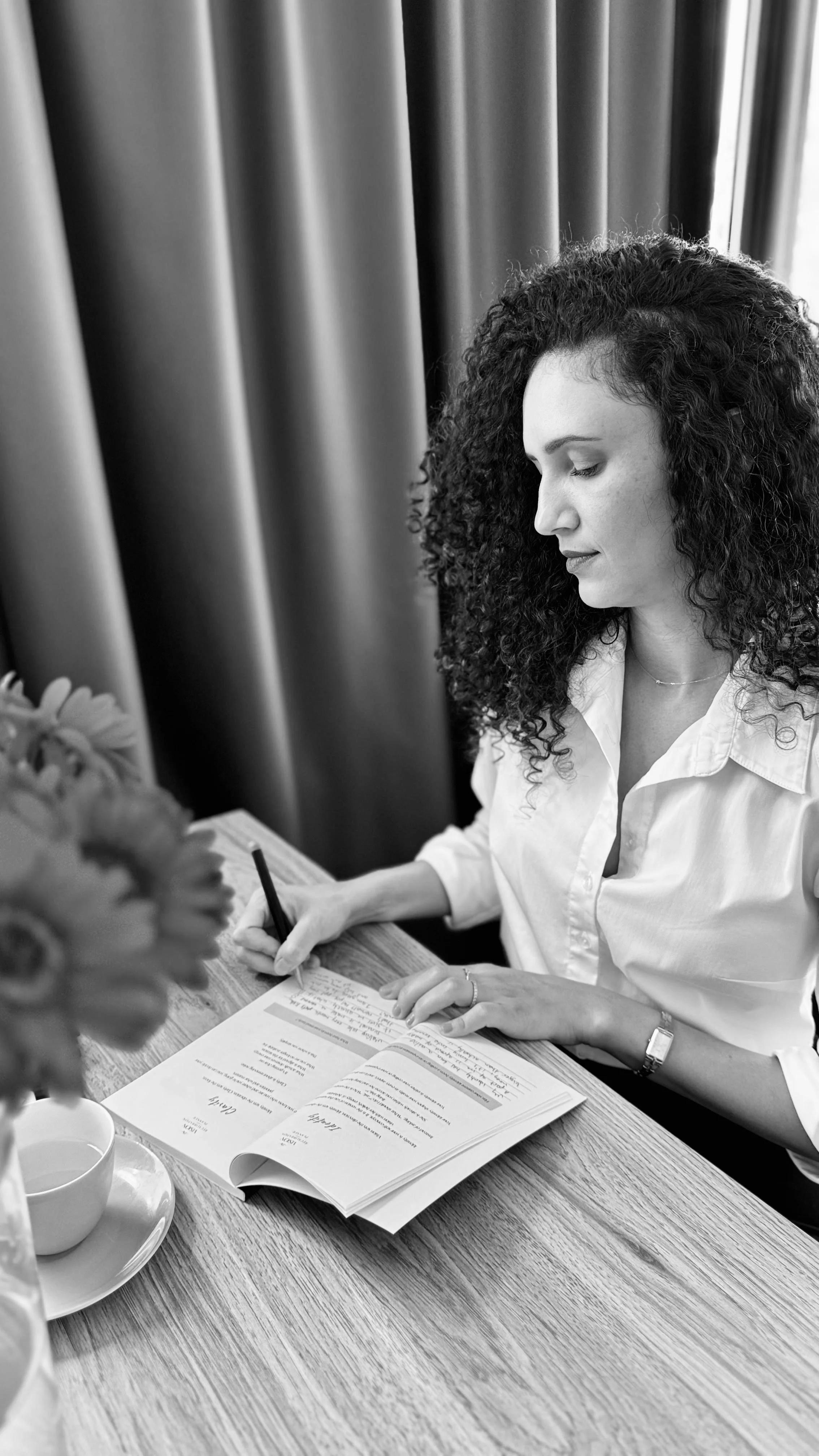 A woman writing on her planner