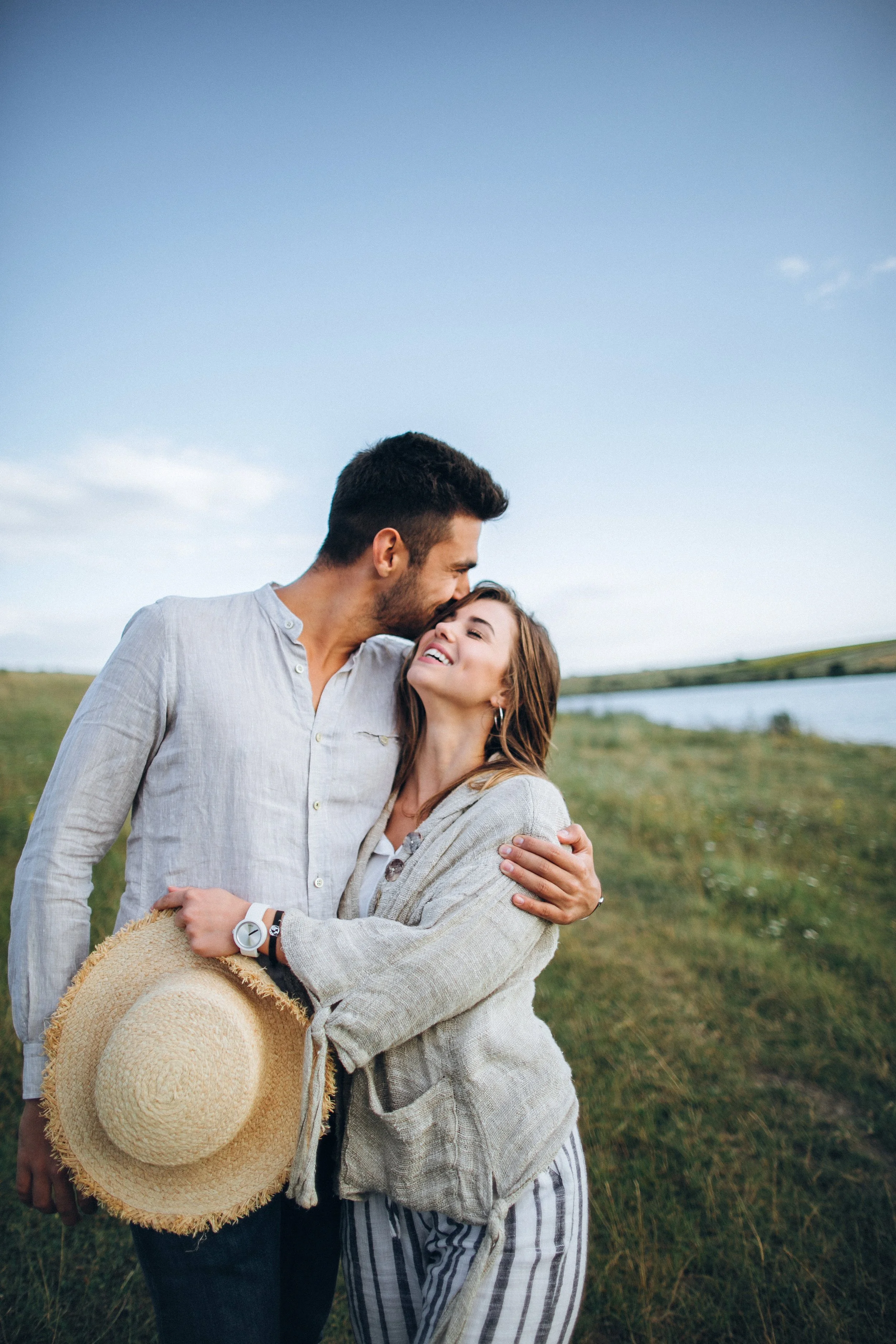 happy-couple-love-hugging-kissing-smiling-against-sky-field-hat-girl-s-hand.jpg