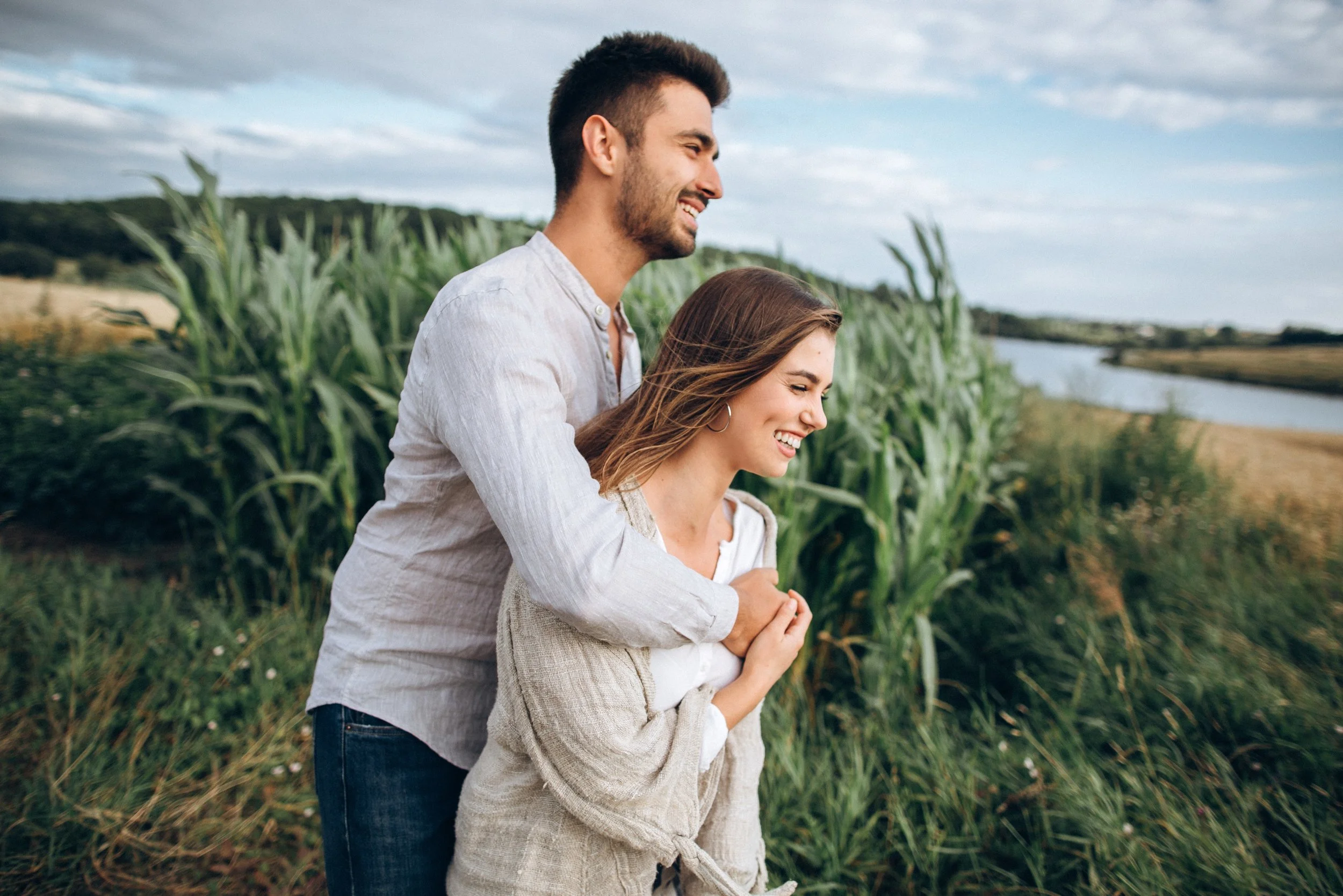 happy-couple-love-hugging-kissing-smiling-against-sky-field-hat-girl-s-hand (2).jpg