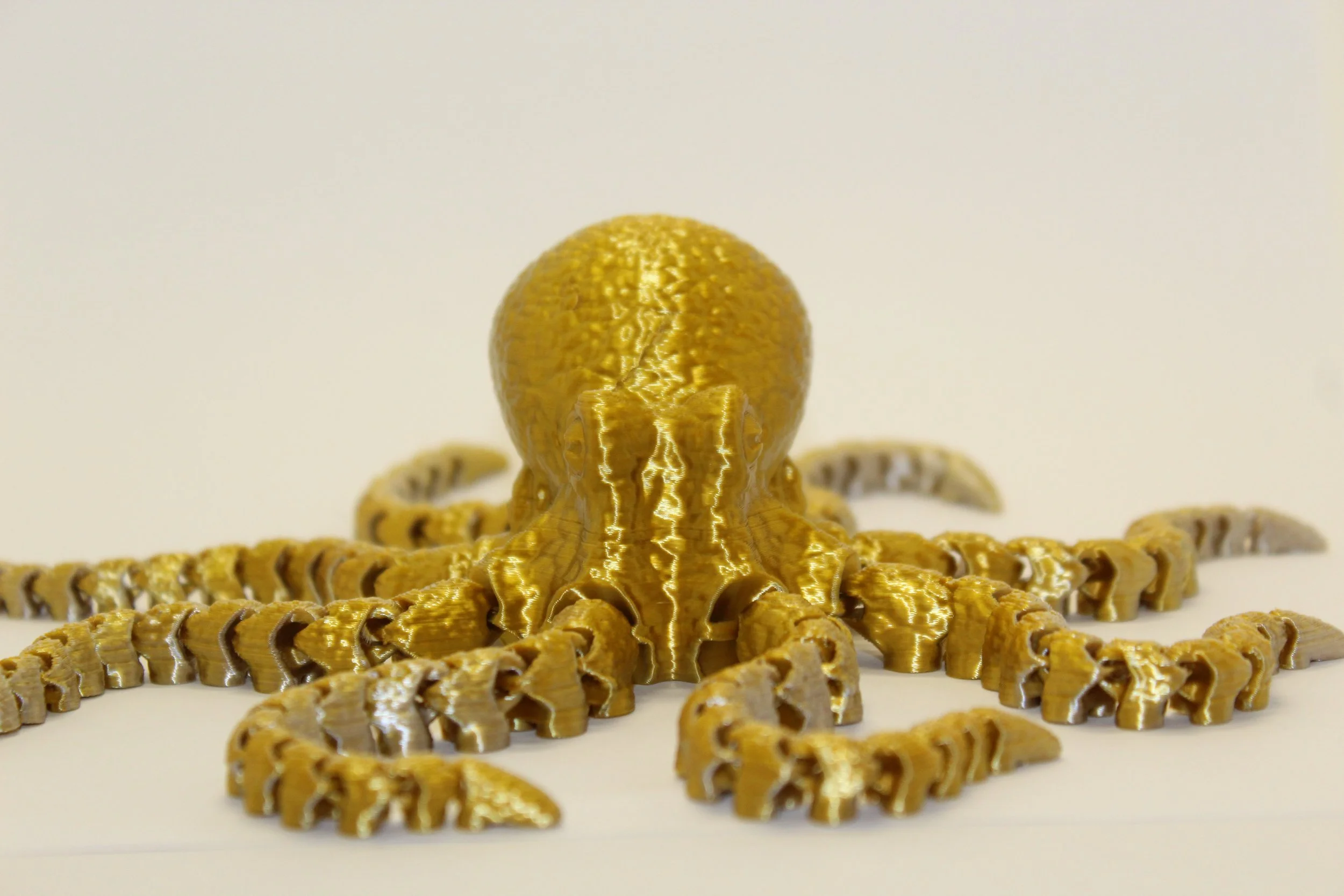 Golden octopus Print with detailed textured head and tentacles, set against a plain white background.