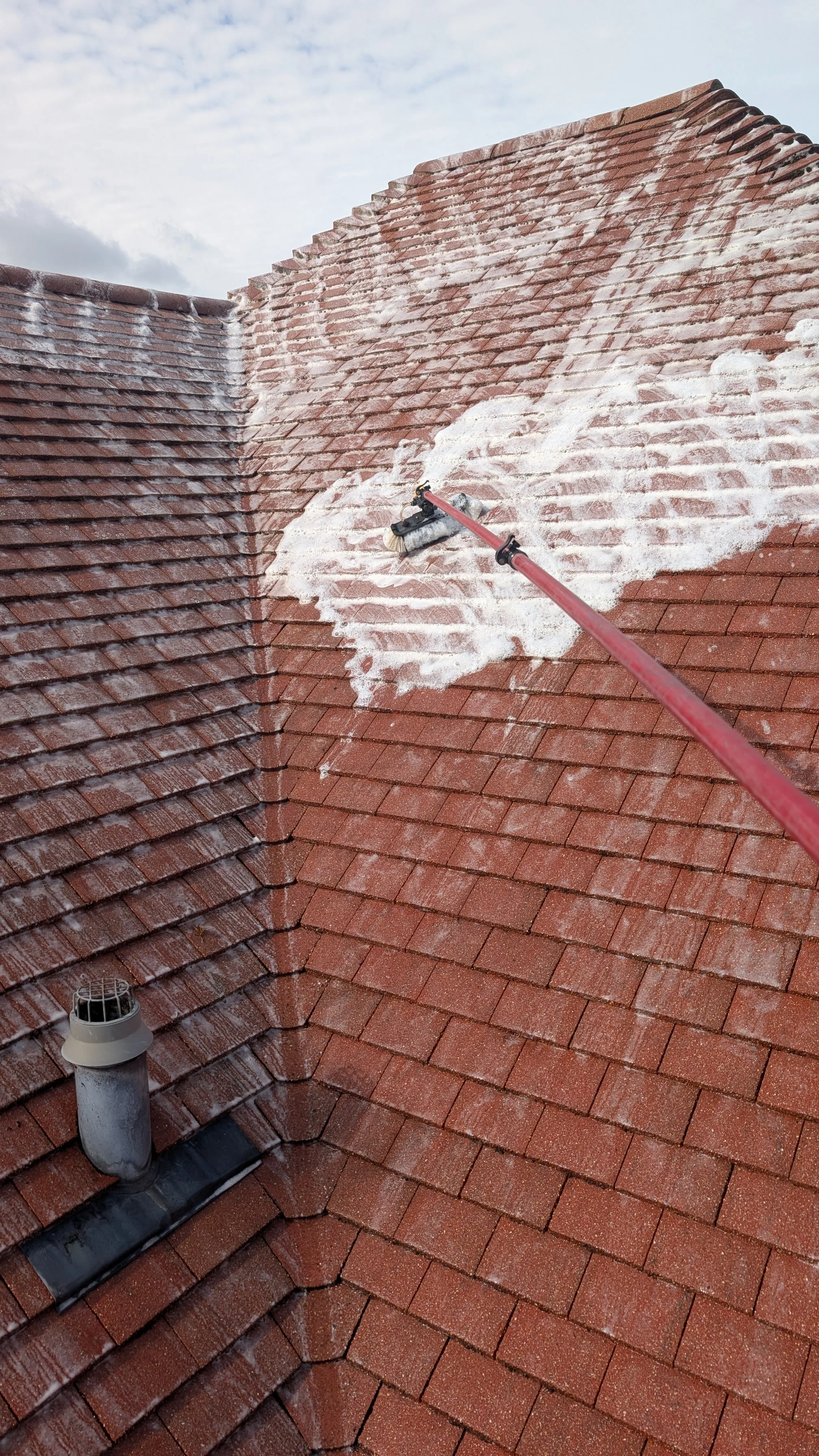 Cleaning a roof in Marlow with biocide. soft washing and pressure washing the roof.