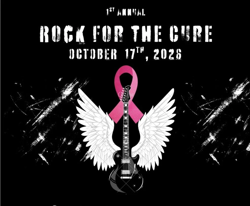 Event poster for the 1st Annual Rock for the Cure on October 17th, 2026, featuring a black background with a pink ribbon, white angel wings, and an electric guitar in the center.