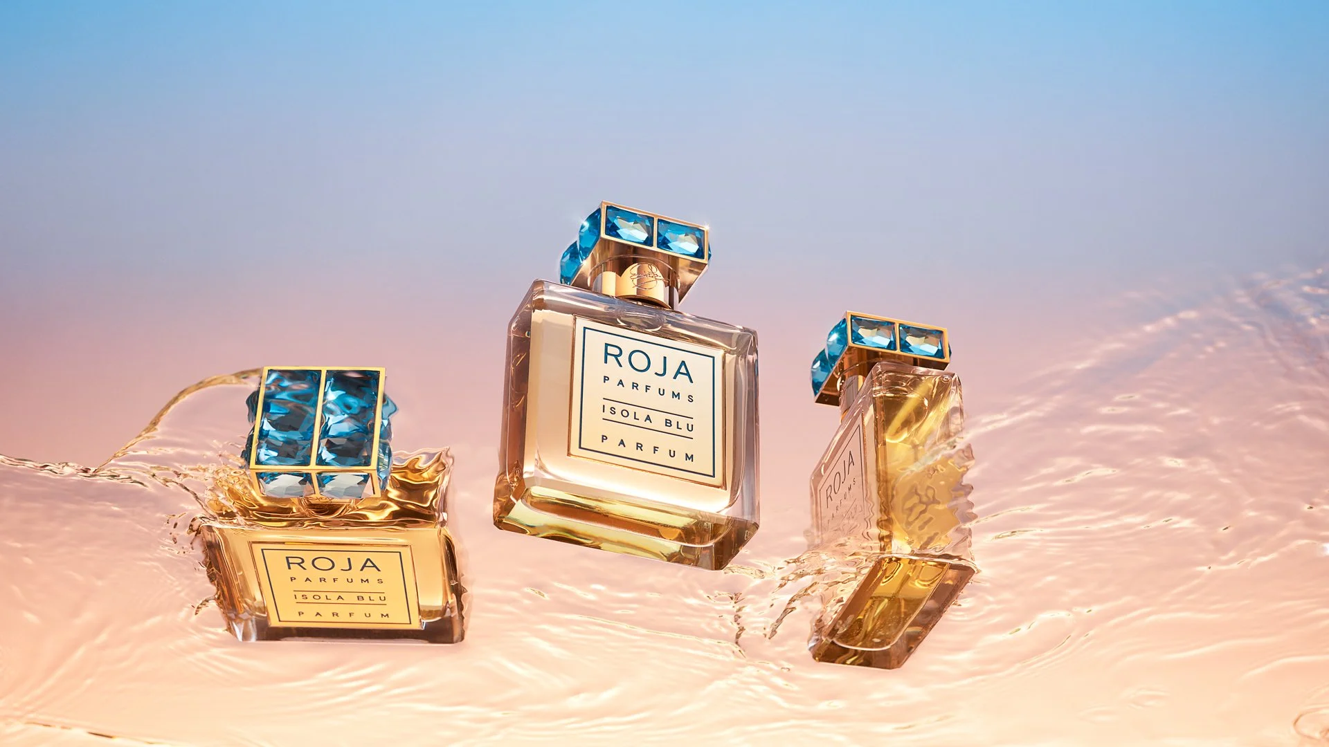Three perfume bottles placed on water.
