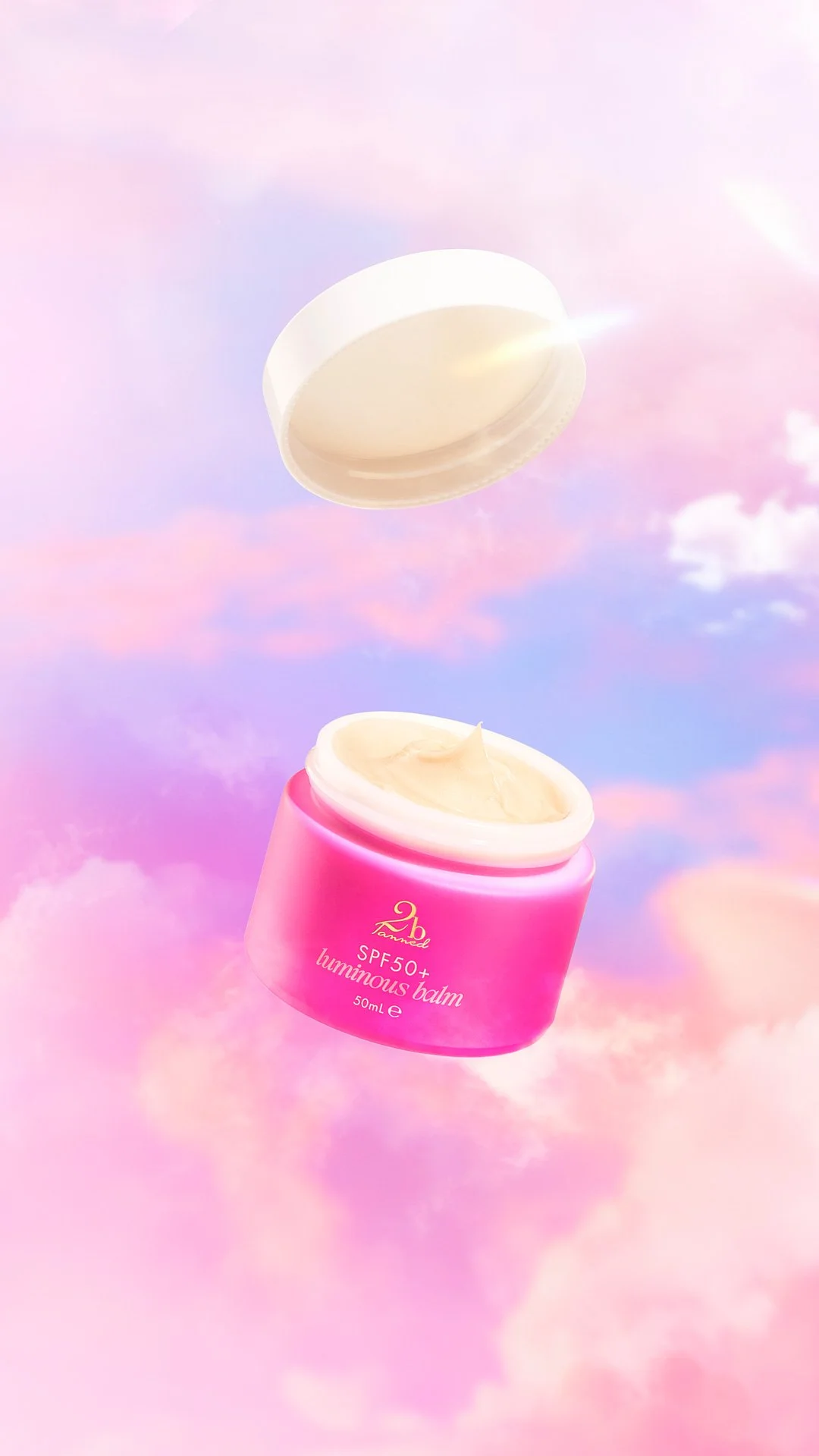 Floating SPF 50 cream in pink clouds