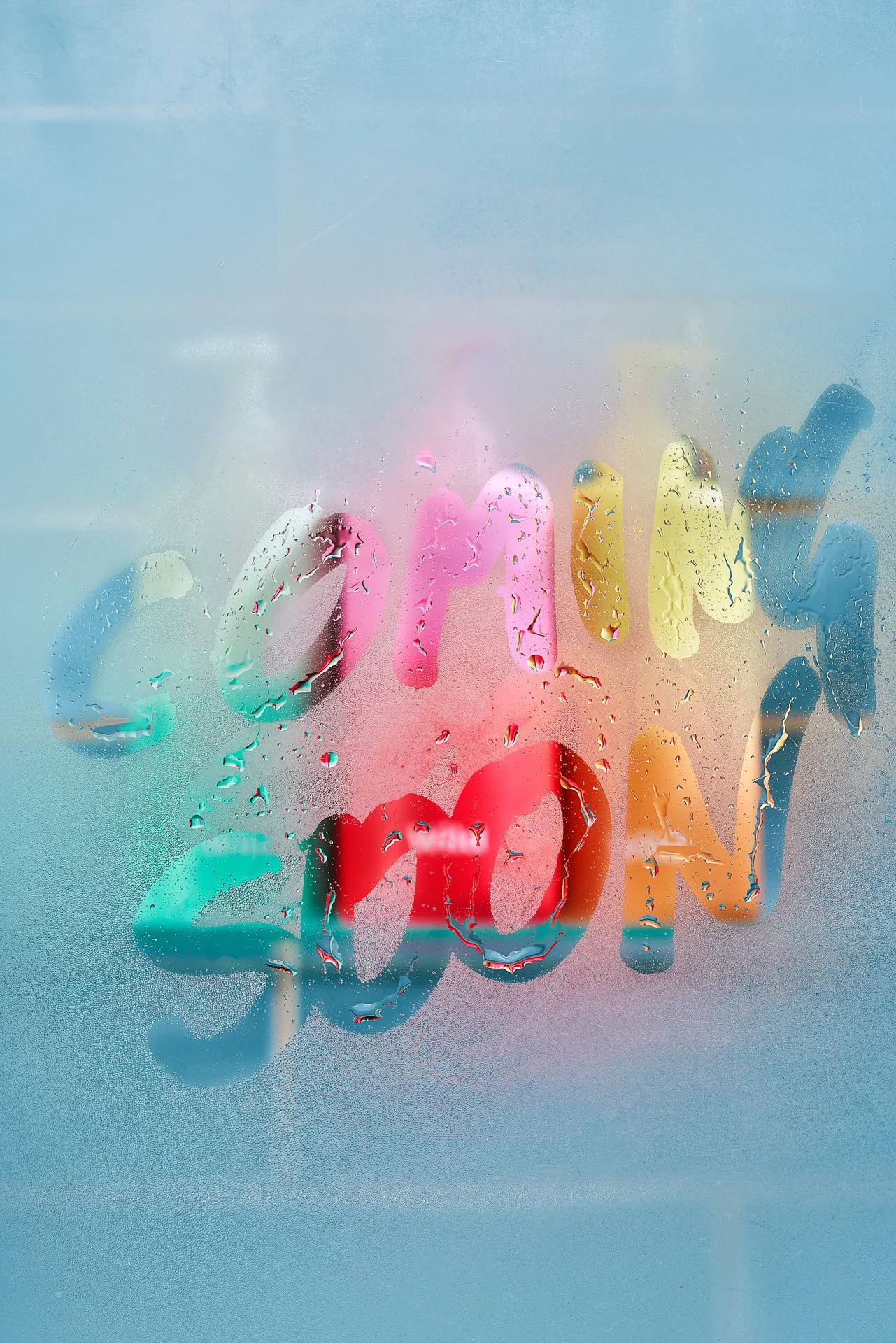 Steamed up shower glass with hand written note 'coming soon'.