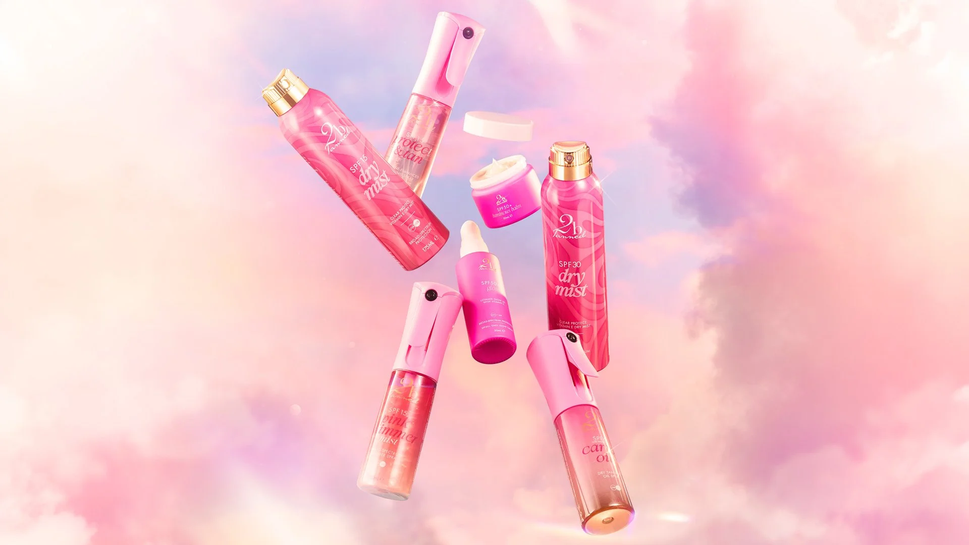 Collection of 2bTanned SPF products, floating in pink clouds.