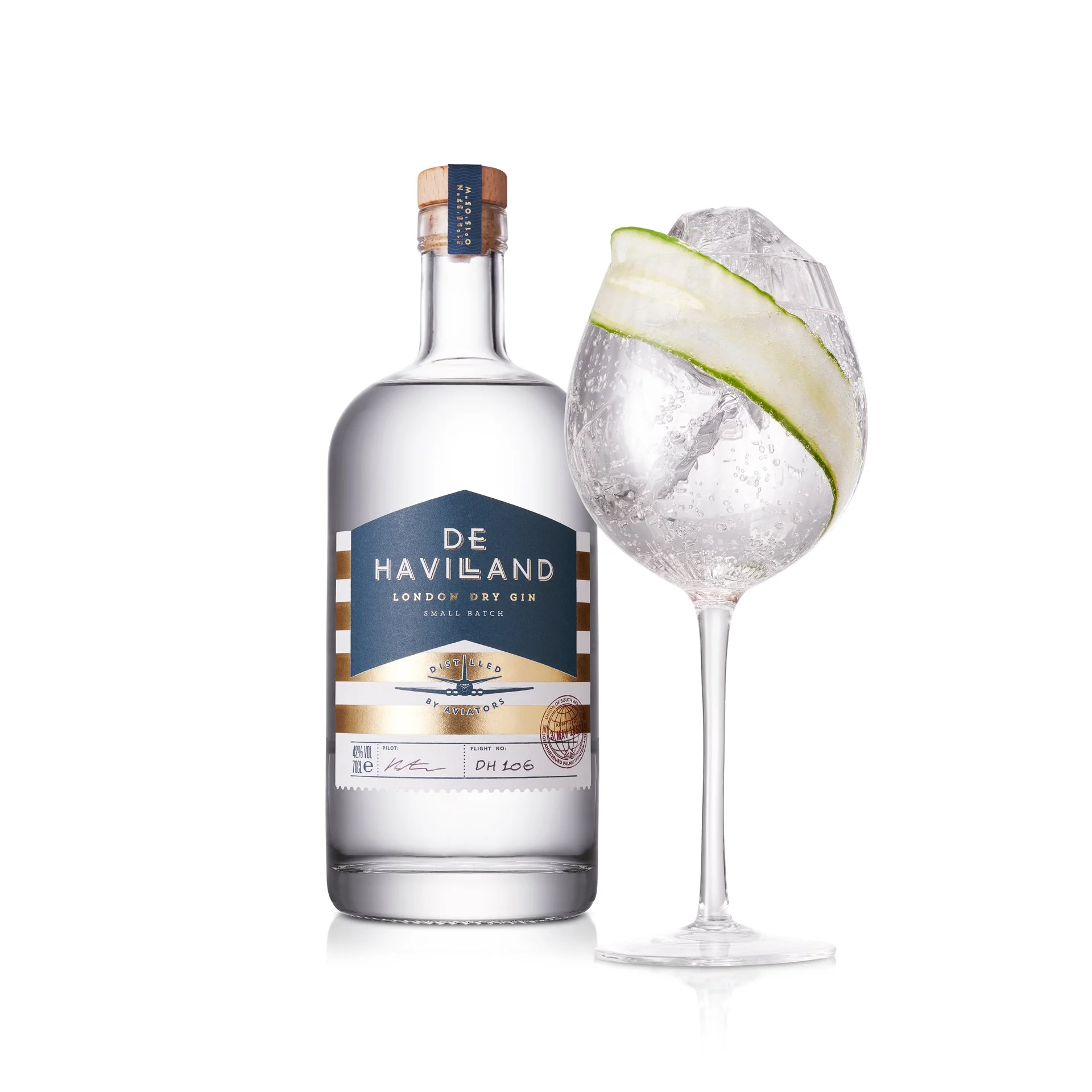 Bottle of De Haveland London Dry Gin next to a gin and tonic glass with lime wedge and ice.