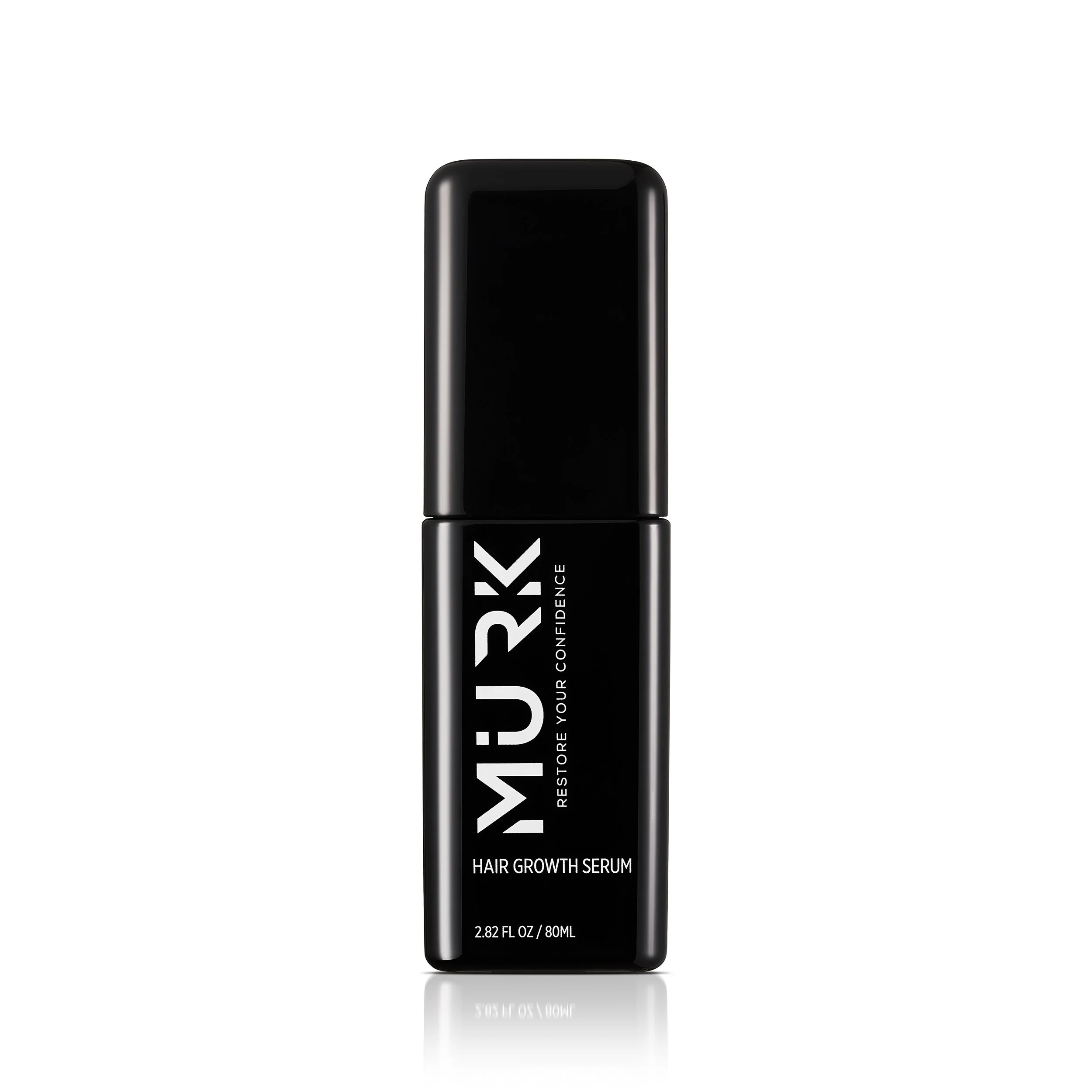 A black bottle of MUJUK Hair Growth Serum with white text on the front, standing upright against a white background.