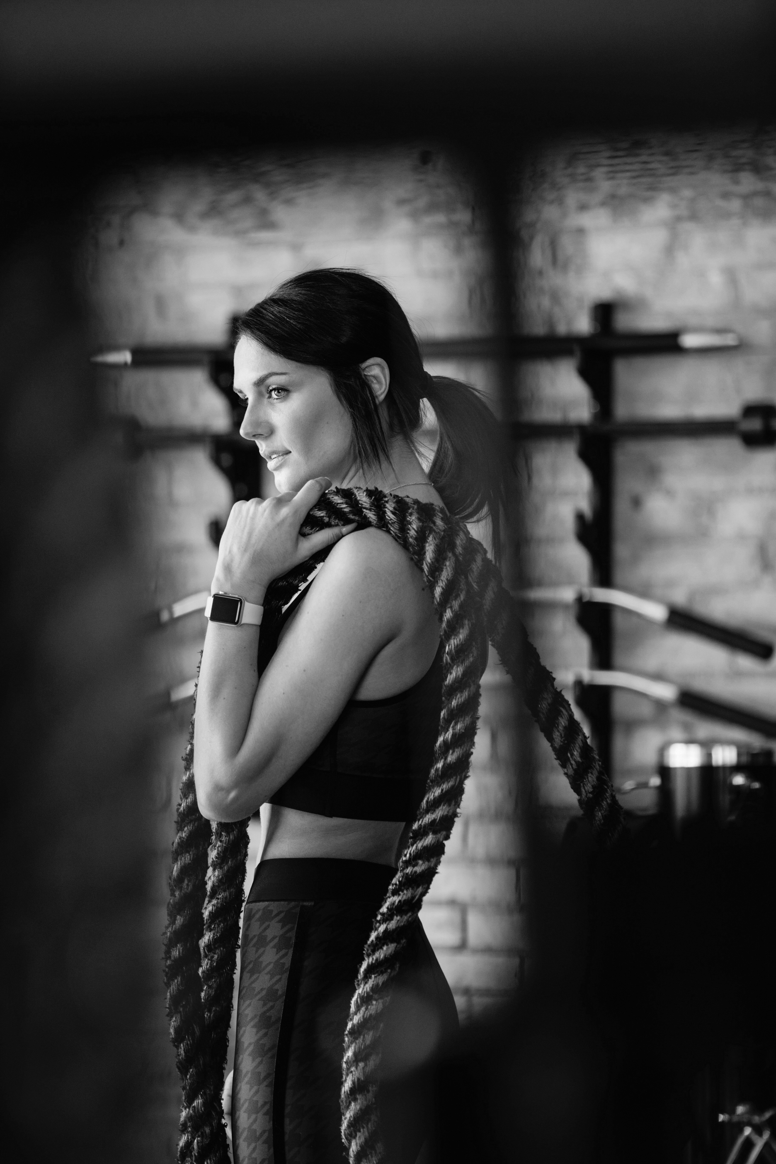 Woman training with battle ropes, representing structured fitness, accountability, and sustainable progress